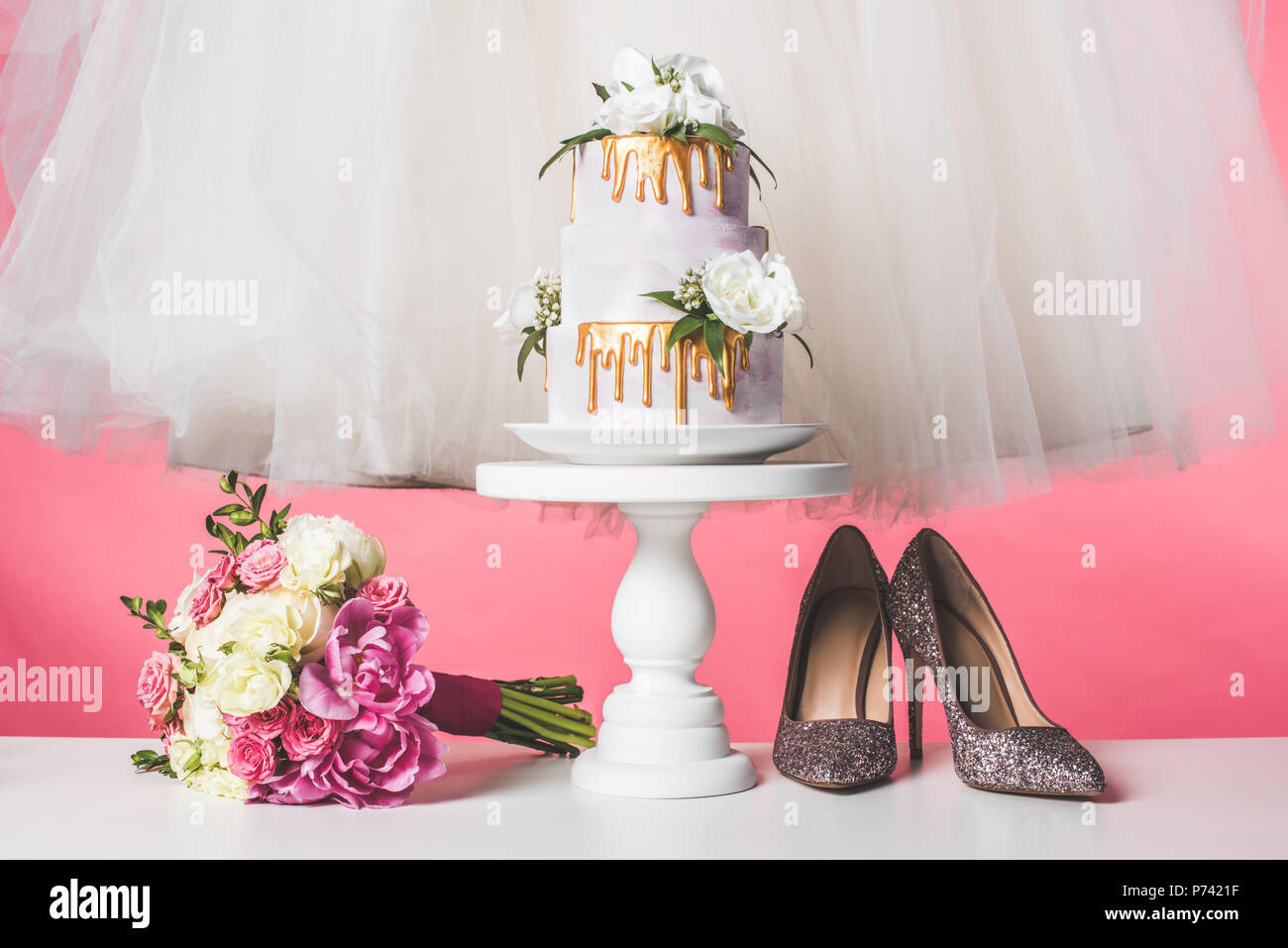 pair of shoes, wedding bouquet, cake and white dress isolated on pink Stock  Photo - Alamy