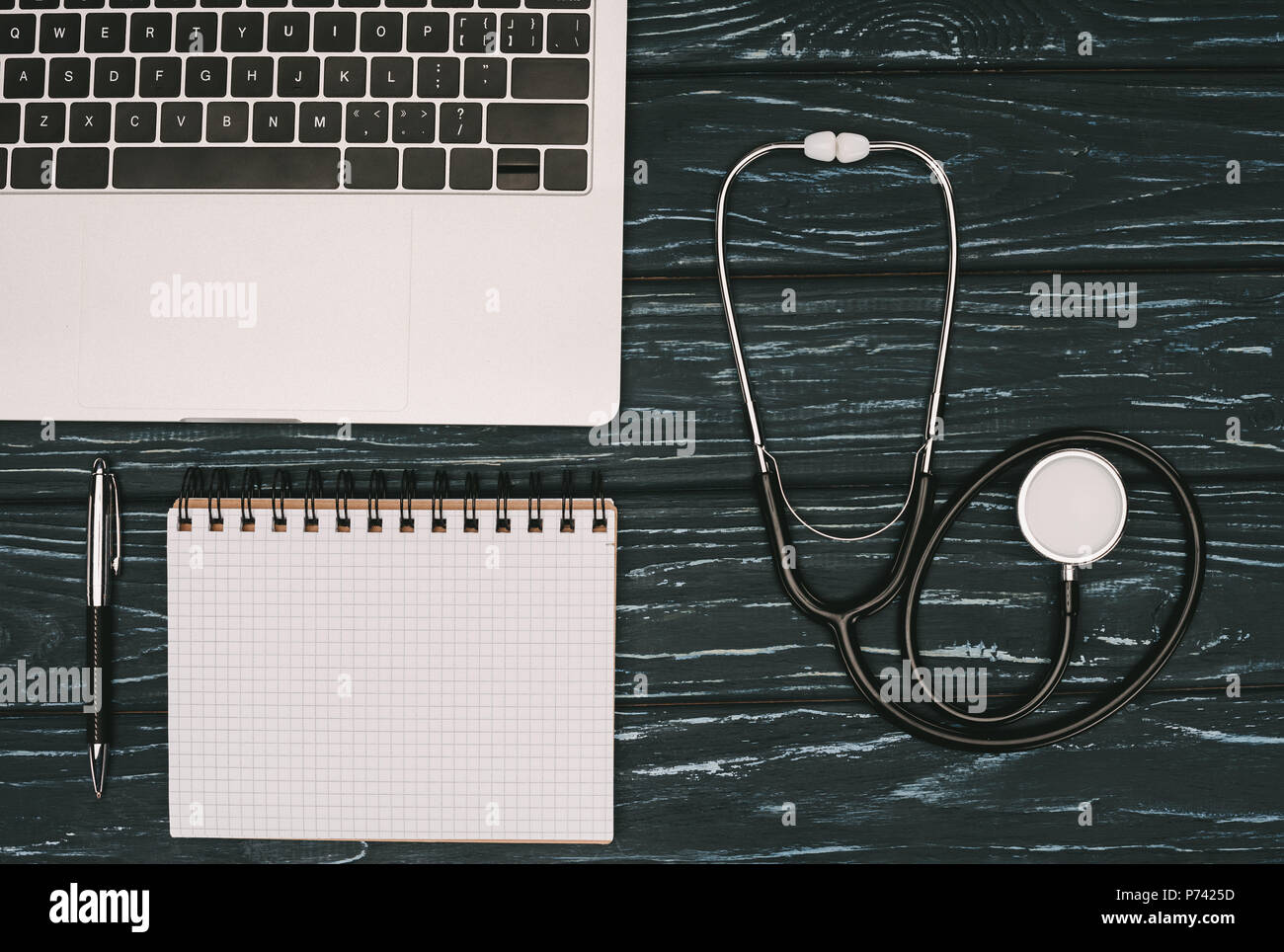 Laptop stethoscope on wooden hi-res stock photography and images - Alamy