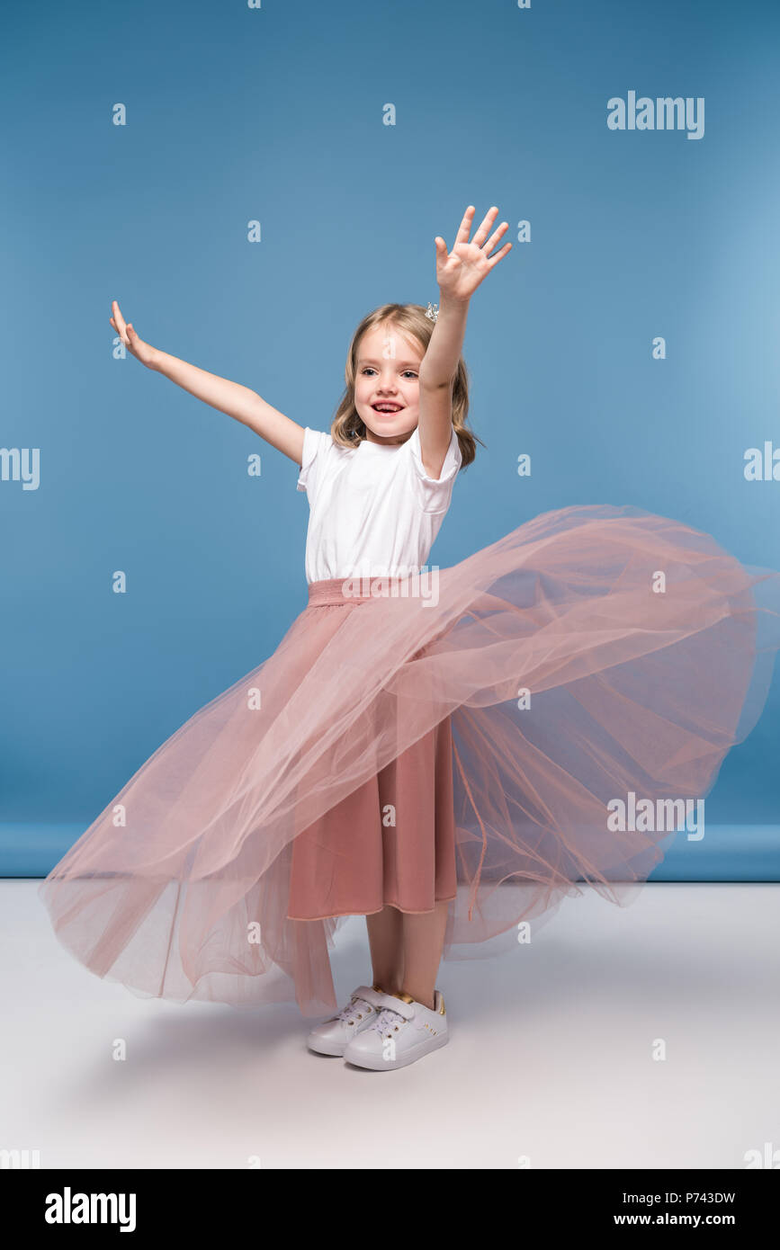 Adorable little girl in pink skirt posing in studio Stock Photo - Alamy