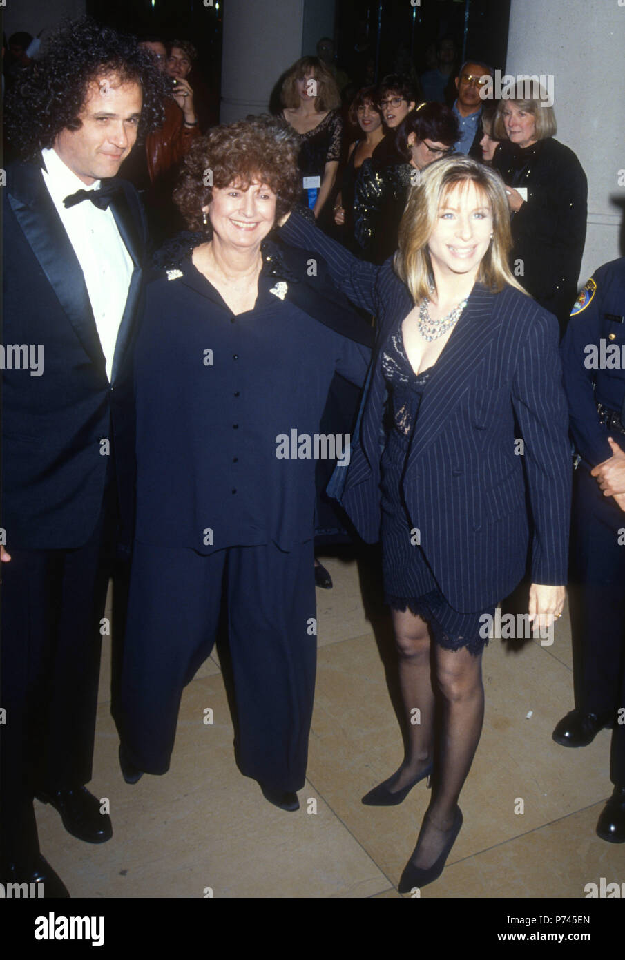 BEVERLY HILLS, CA - JANUARY 18: (L-R) Composer Richard Baskin, guest and Singer/actress Barbra Streisand attend the 49th Annual Golden Globe Awards on January 19, 1992 at the Beverly Hilton Hotel in Beverly Hills, California. Photo by Barry King/Alamy Stock Photo Stock Photo