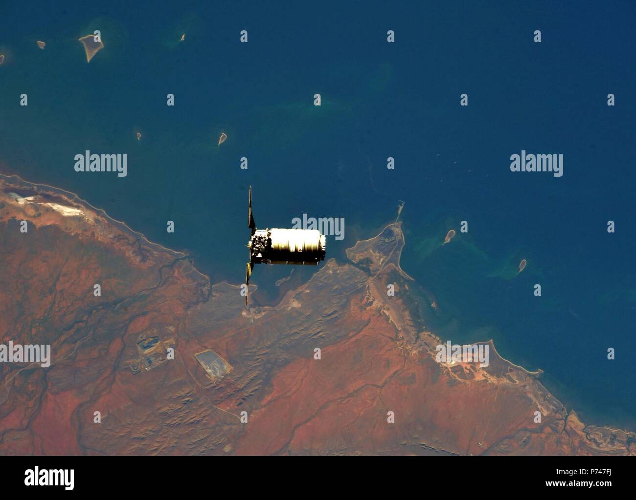 The Northrop Grumman Orbital ATK Cygnus commercial cargo spacecraft approaches the International Space Station for docking over the coast of Australia April 22, 2018 in Earth Orbit. Stock Photo