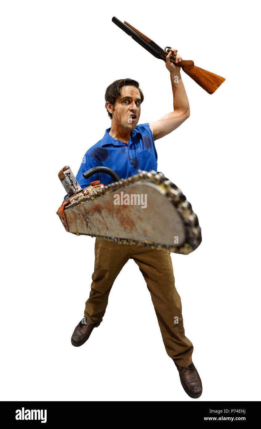 Villain with a chainsaw and sawed off shotgun on white background. Stock Photo