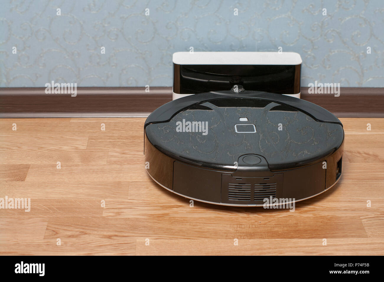 black Robot vacuum cleaner on charging dock after it is finished