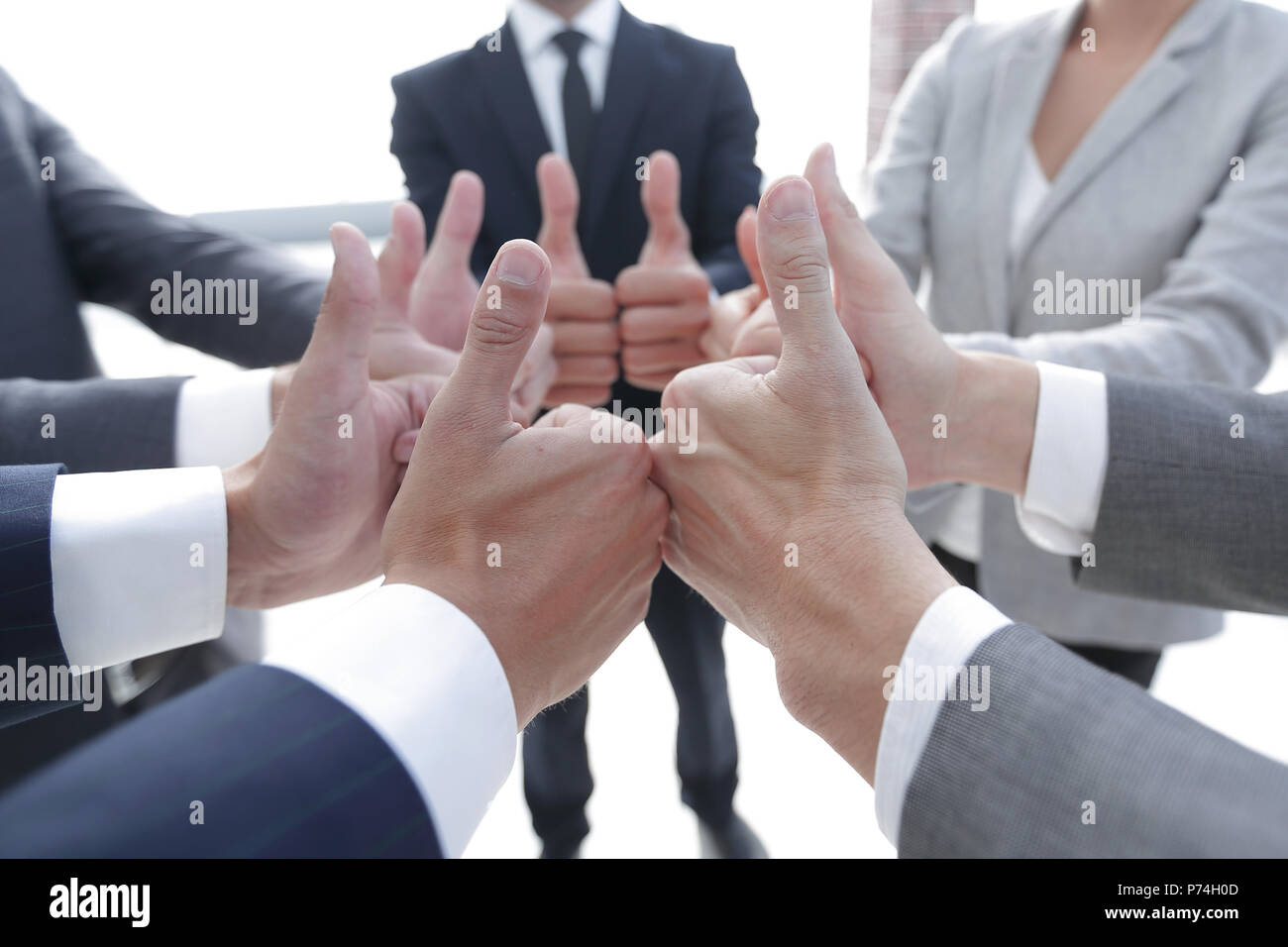 business team showing thumbs up Stock Photo - Alamy