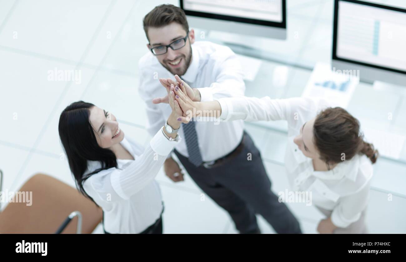 successful business team giving each other a high five Stock Photo - Alamy