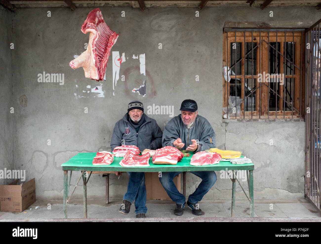 Khidistavi, Georgia - December 1, 2016 : two men selling freshly slaughtered pork meat by the road Stock Photo