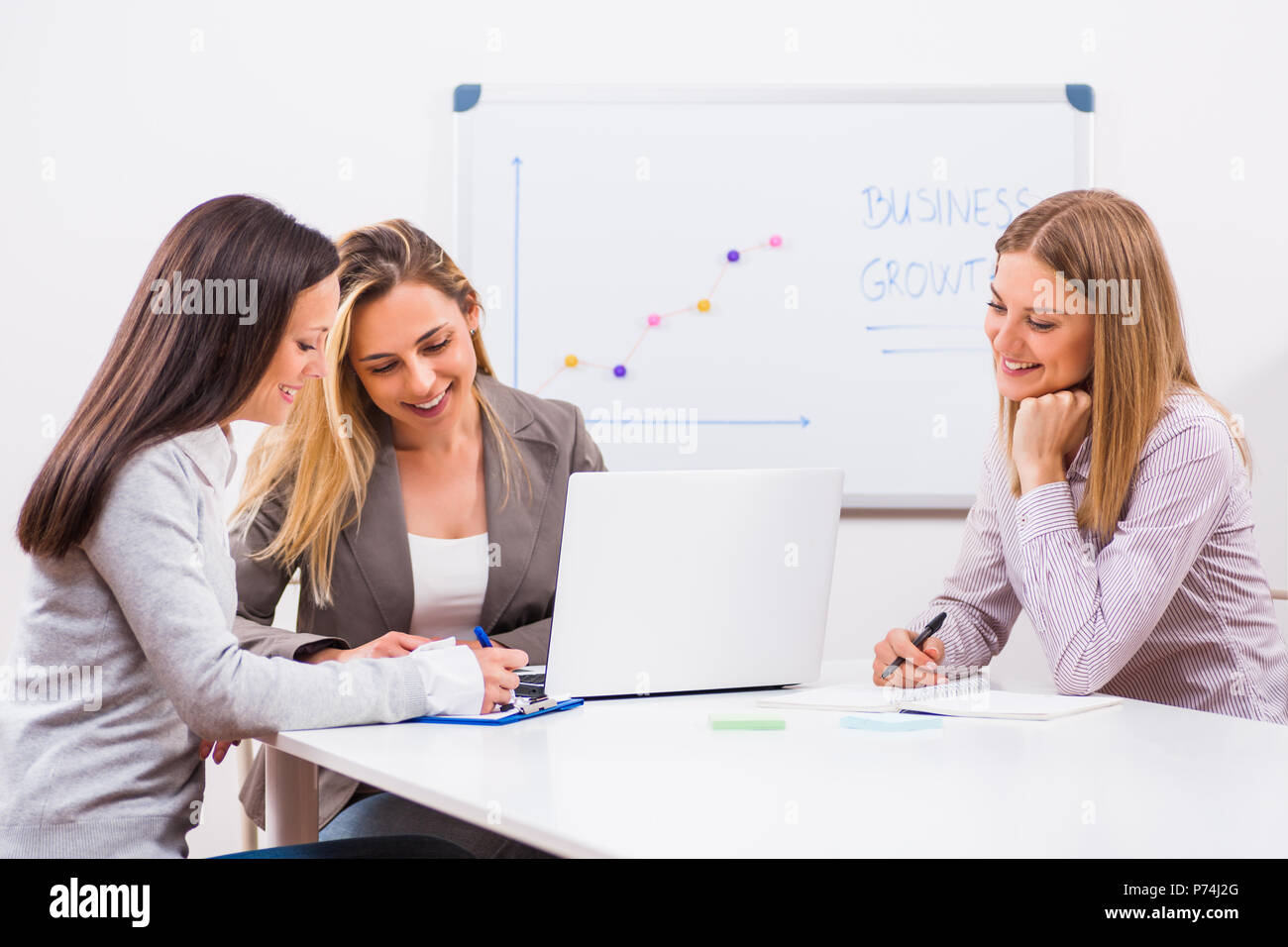 Three businesswomen are having meeting in their office Stock Photo - Alamy