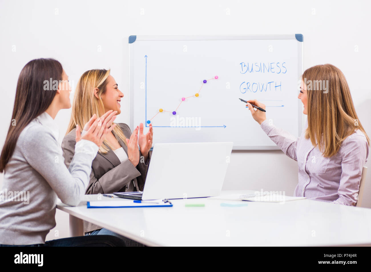 Three businesswomen are having meeting in their office Stock Photo - Alamy