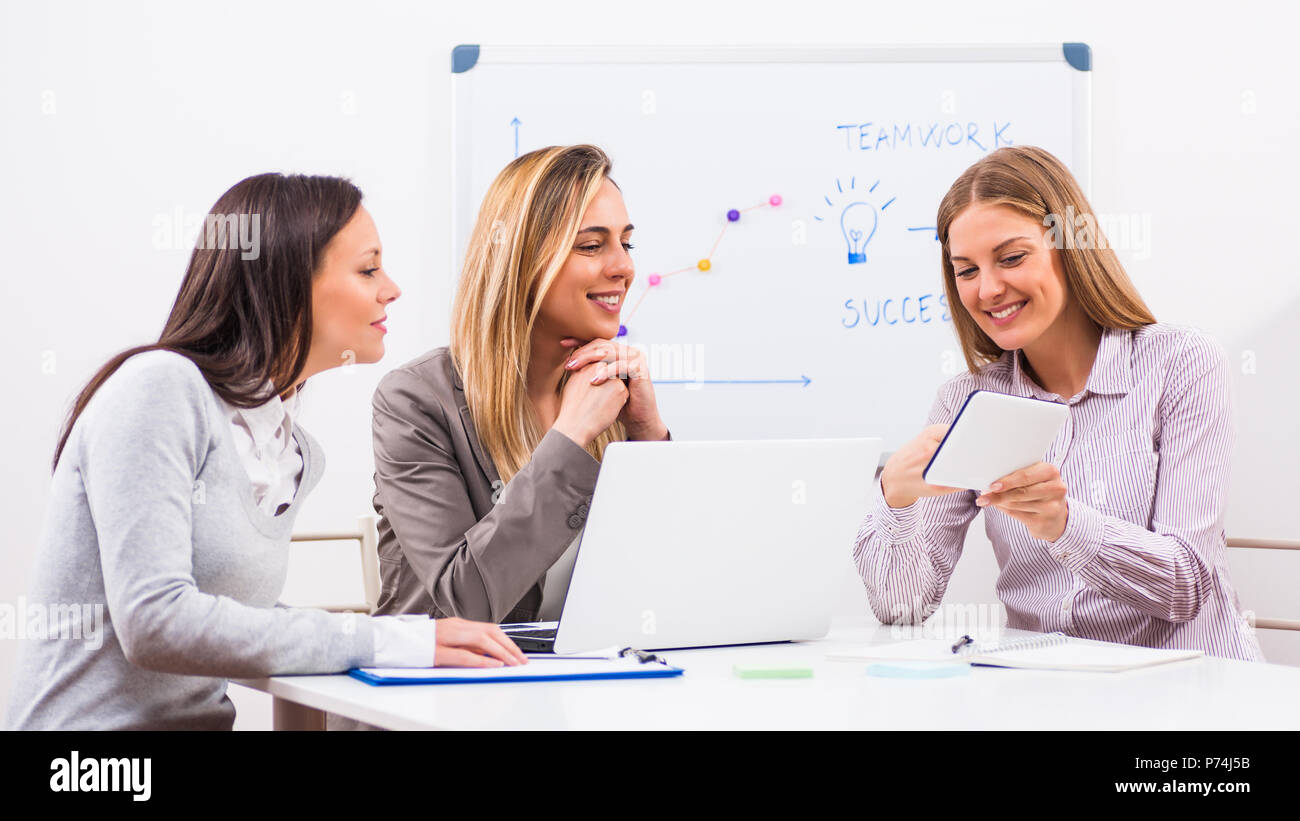 Three businesswomen are having meeting in their office Stock Photo - Alamy