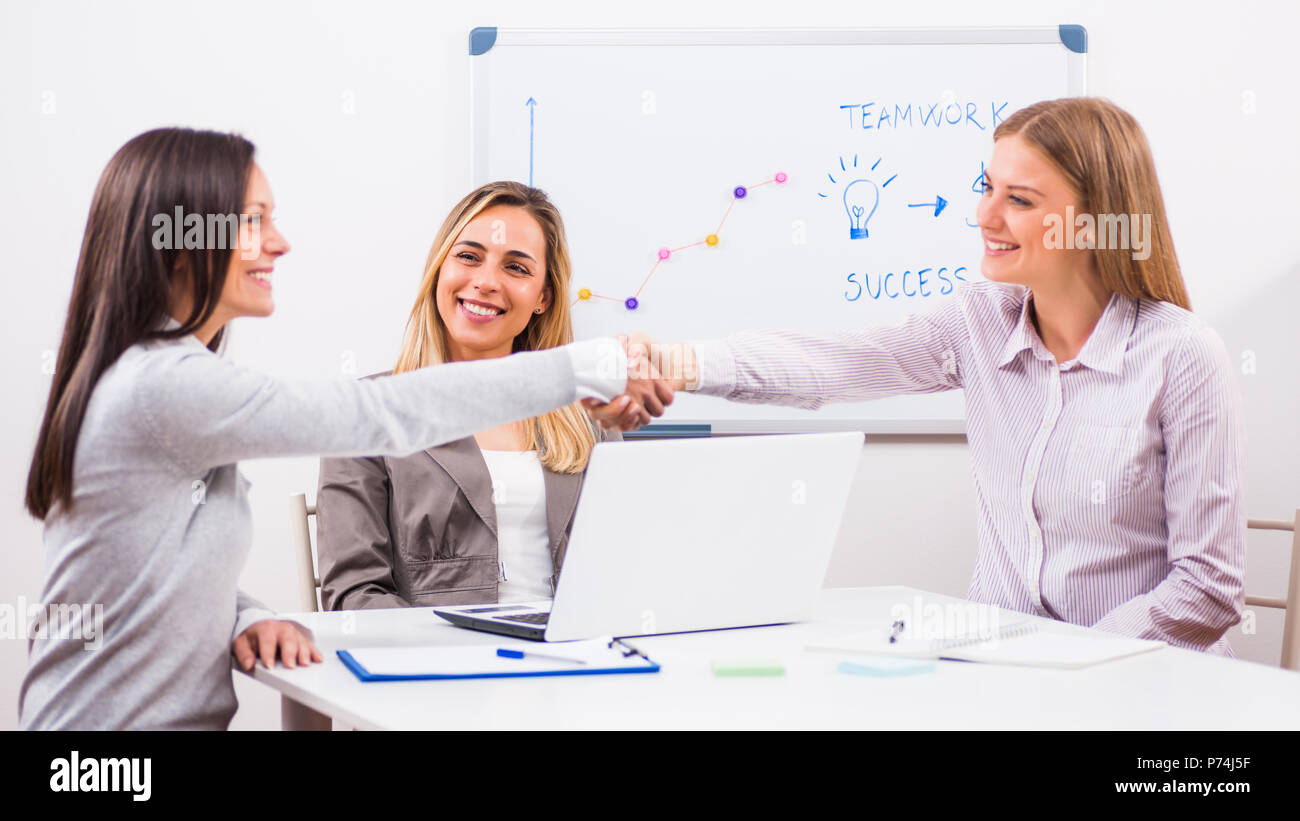Three businesswomen are having meeting in their office Stock Photo - Alamy