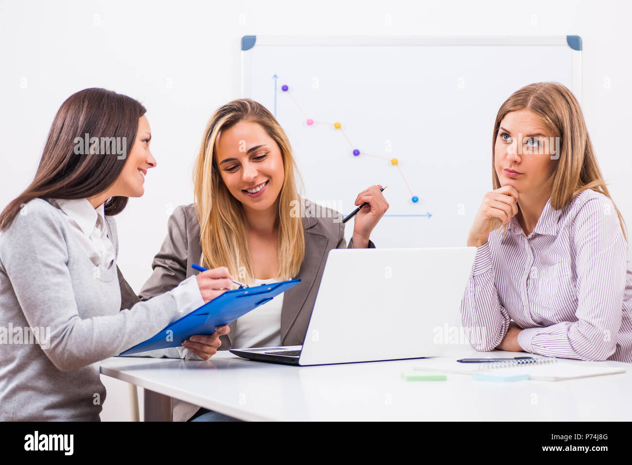 Three businesswomen are having meeting in their office Stock Photo - Alamy