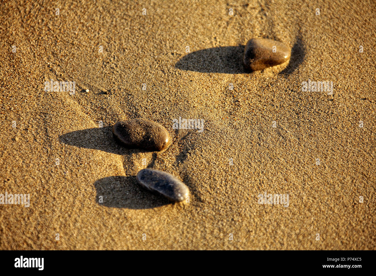 Pebble stones on sandy beach hi-res stock photography and images - Alamy