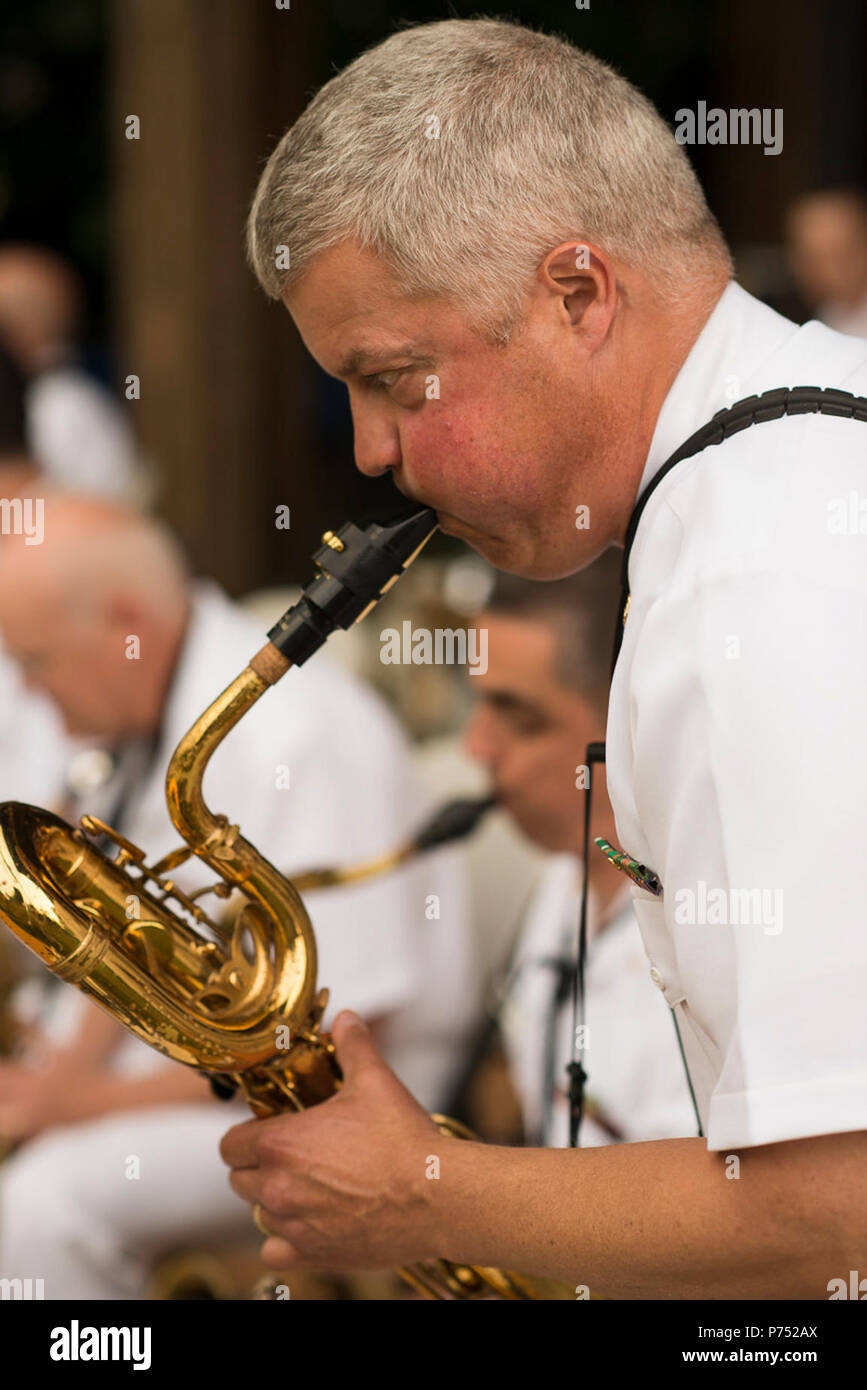 VIENNA, Va. (May 29, 2015) Chief Musician Rob Holmes, of McLean, Va., takes a baritone saxophone solo with the U.S. Navy Band Commodores at Vienna's Summer on the Green Concert Series. The concert marks the start of the Commodores' busy summer concert season. Stock Photo