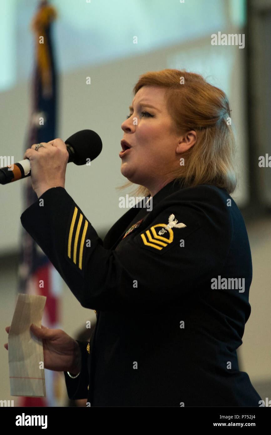 ANNANDALE, VIRGINIA  (October 30, 2016) Chief Petty Officer Rachel Sarracco sings with the U.S. Navy Band Sea Chanters chorus during their' 60th anniversary concert. The Sea Chanters celebrated their 60th anniversary with a concert in Annandale, Virginia, featuring alumni from the group. The chorus was formed as an all-male group in 1956 and tasked with perpetuating the songs of the sea. In 1980, the group added women to their ranks and expanded their repertoire to include everything from Brahms to Broadway. Stock Photo