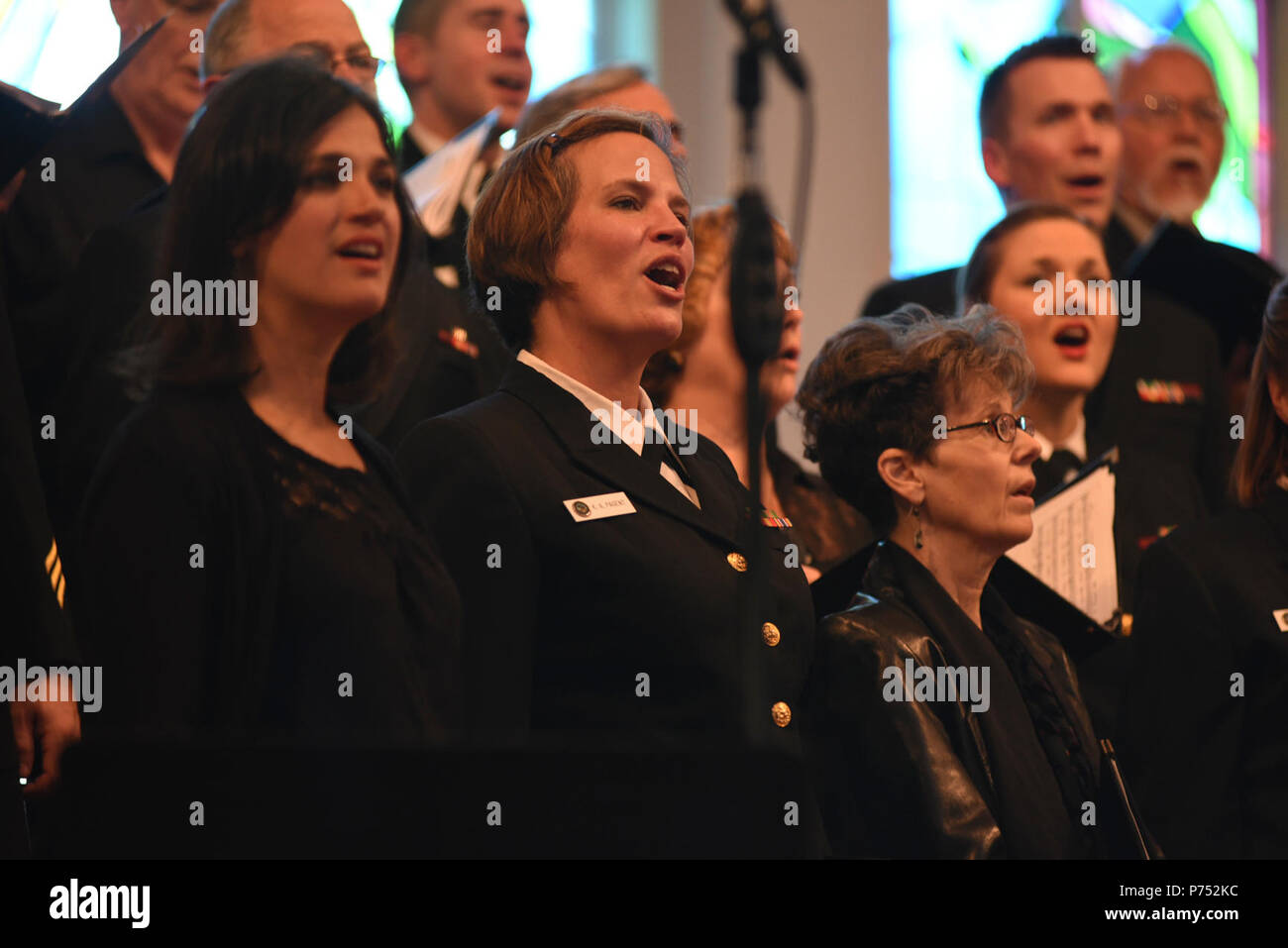 ANNANDALE, VIRGINIA  (October 30, 2016) Petty Officer 1st Class Kristen Pagent, center, performs with the U.S. Navy Band Sea Chanters chorus during their 60th anniversary concert. The Sea Chanters chorus celebrated their 60th anniversary iin Annandale, Virginia, with a concert featuring alumni from the group. The chorus was formed as an all-male group in 1956 and tasked with perpetuating the songs of the sea. In 1980, the group added women to their ranks and expanded their repertoire to include everything from Brahms to Broadway. Stock Photo