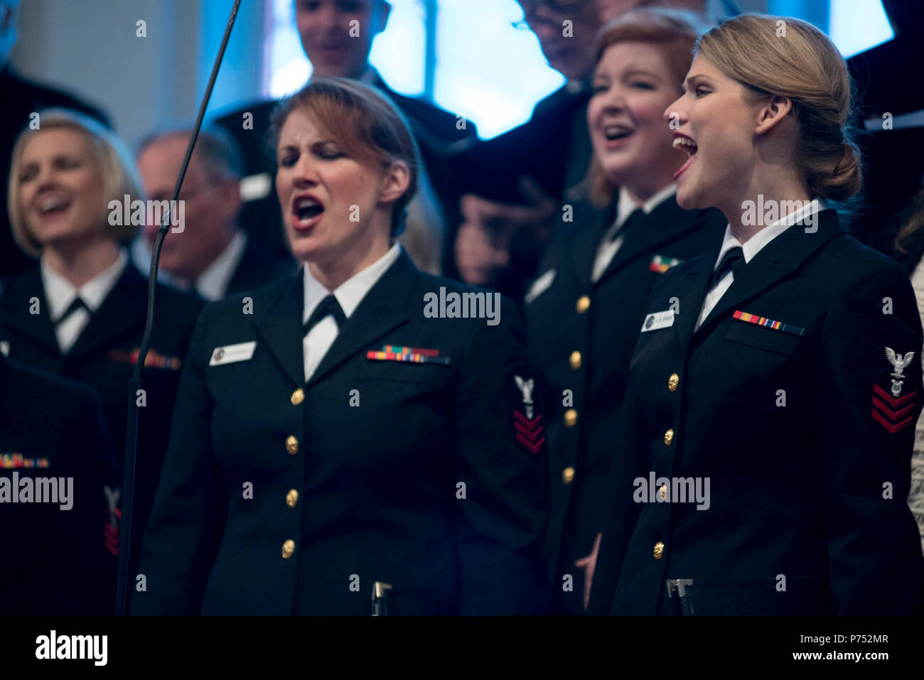 ANNANDALE, VIRGINIA  (October 30, 2016) Petty Officers 1st Class Maia Rodriguez, left and Chelsi Ervein, as they perform with the U.S. Navy Band Sea Chanters chorus during the chourus' 60th anniversary concert. The Sea Chanters chorus celebrated their 60th anniversary iin Annandale, Virginia, with a concert featuring alumni from the group. The chorus was formed as an all-male group in 1956 and tasked with perpetuating the songs of the sea. In 1980, the group added women to their ranks and expanded their repertoire to include everything from Brahms to Broadway. Stock Photo