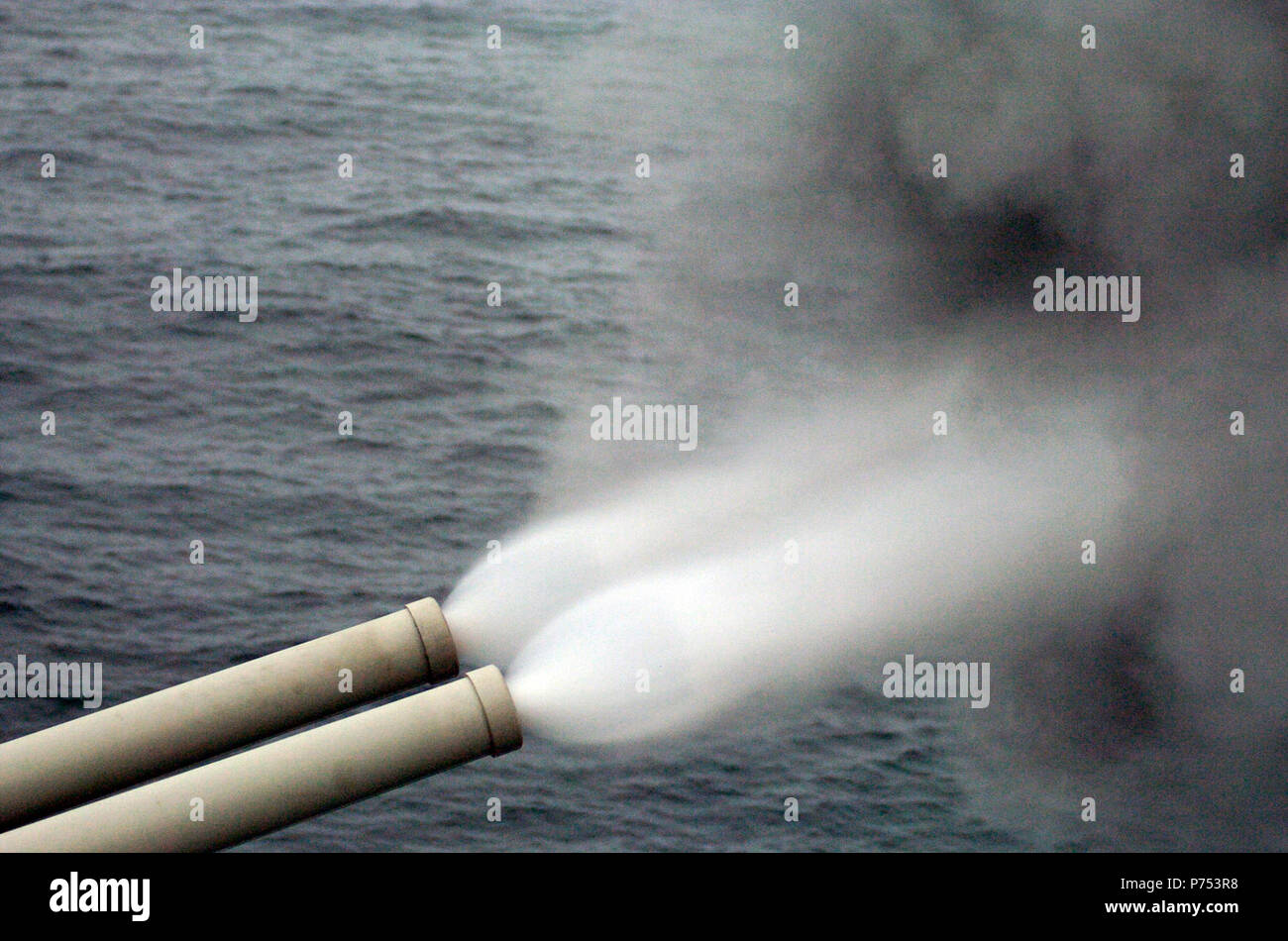 ABOARD ALMIRANTE GRAU IN PACIFIC OCEAN (July 3, 2004) - The Peruvian light missile cruiser B.A.P. Almirante Grau (CLM-81) fires 15.2 cm caliber cannons for naval surface fire support of the largest Latin American amphibious assault ever during UNITAS 45-04.  Eleven partner nations from the U.S. and Latin America came together for the largest multilateral exercise in the Southern Hemisphere.  U.S. Navy Stock Photo