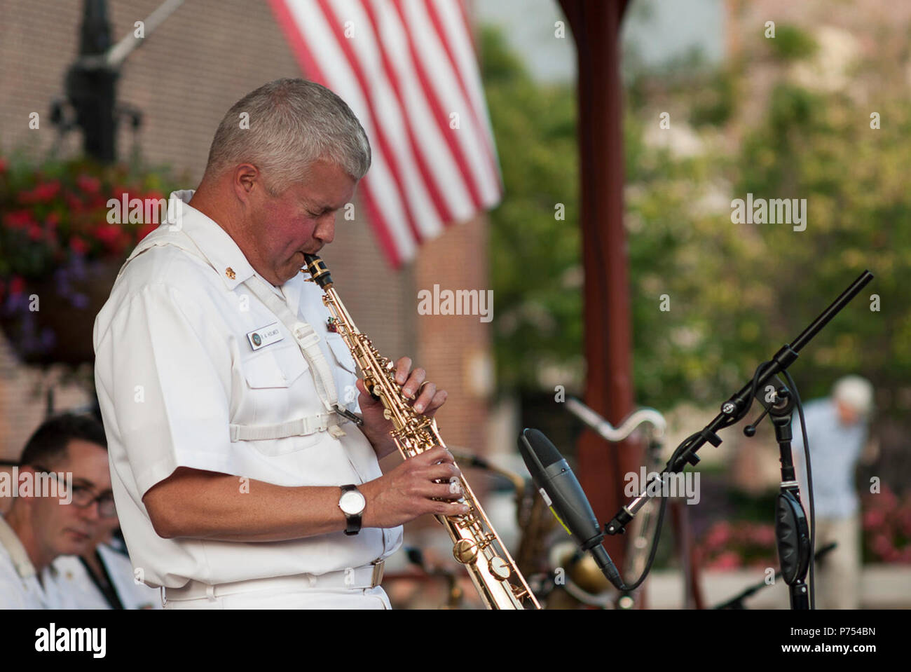 ALEXANDRIA, Va. (August 28, 2015) Chief Musician Rob Holmes, of McLean, Va., takes a soprano saxophone solo with the United States Navy Band Commodores jazz ensemble at Market Square in Old Town. The Commodores play free public concerts throughout the year. Stock Photo