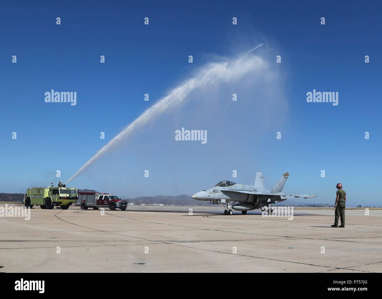 Maj. Gen. Mark R. Wise, the commanding general for 3rd Marine Aircraft Wing, is sprayed with water to celebrate his return from his final flight in an F/A-18C Hornet at Marine Corps Air Station Miramar, San Diego, Calif., July 02. Maj. Gen. Wise flew for the last time as the commanding general of 3rd MAW. (U.S. Marine Corps Photo by Cpl. Joshua S. McAlpine/Released) Stock Photo