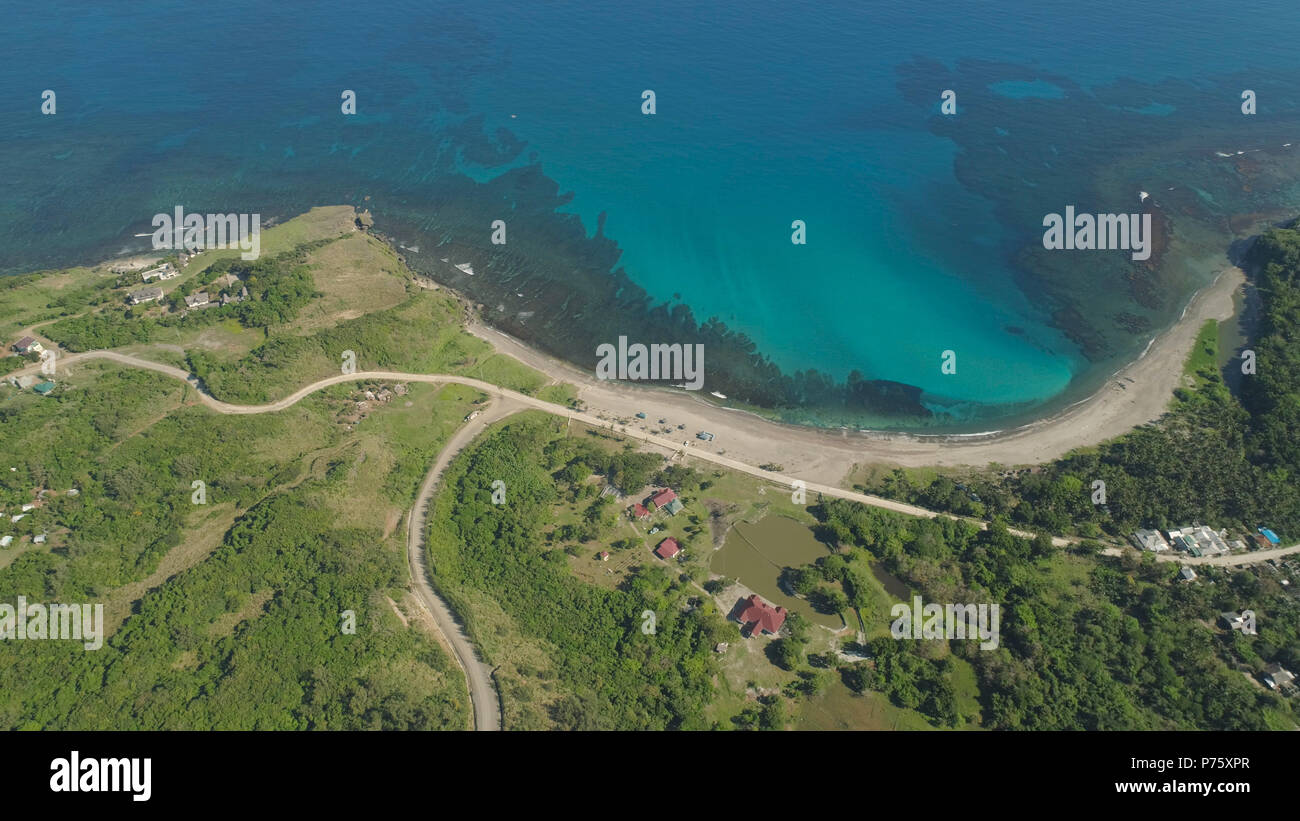 Aerial view of beautiful beach, lagoon and coral reefs. Philippines, Pagudpud. Ocean coastline with turquoise water. Tropical landscape in Asia. Stock Photo