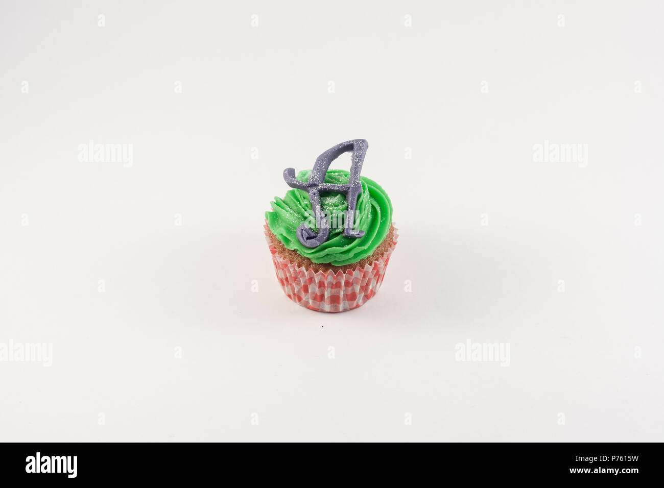 A Cupcake decorated with alice in wonderland Stock Photo