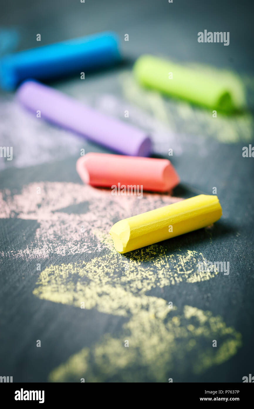 Colorful crayons on the blackboard, drawing. Back to school background. Stock Photo