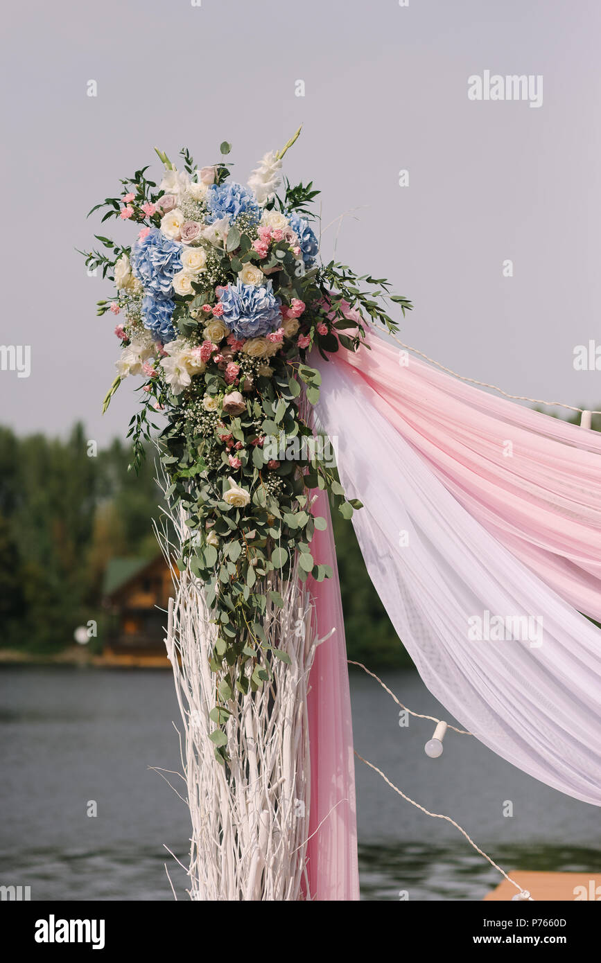 The Wedding Arch Decorated With Flowers And Fabric Stock Photo