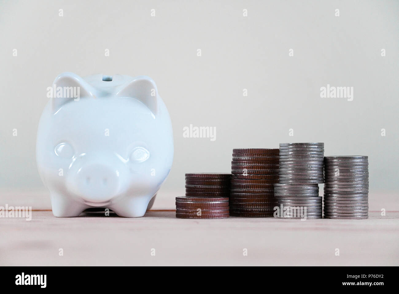 Piggy bank and stack of coin Stock Photo - Alamy