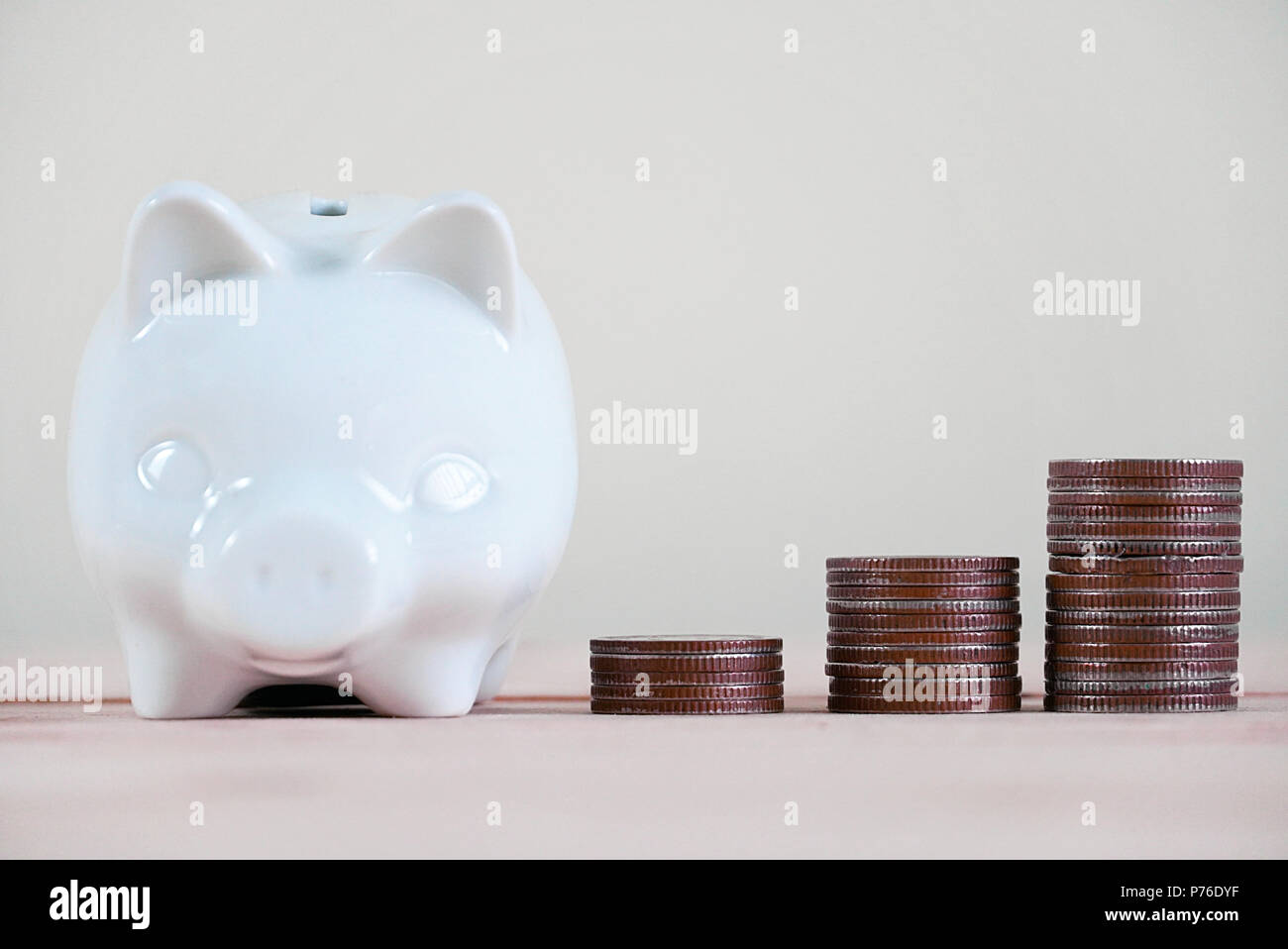 Piggy bank and stack of coin Stock Photo - Alamy