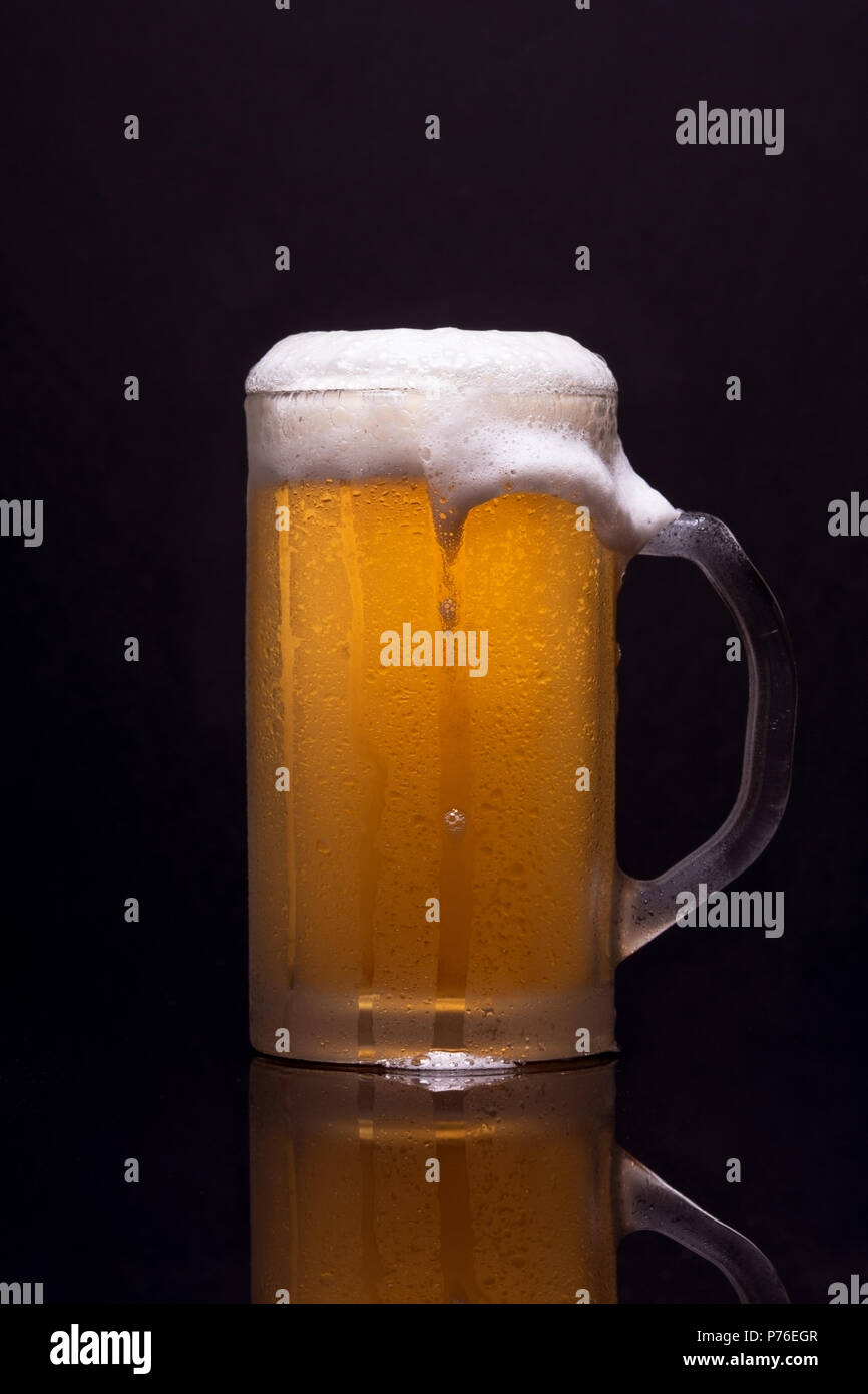 Cold beer with beer and reflection on dark background Stock Photo