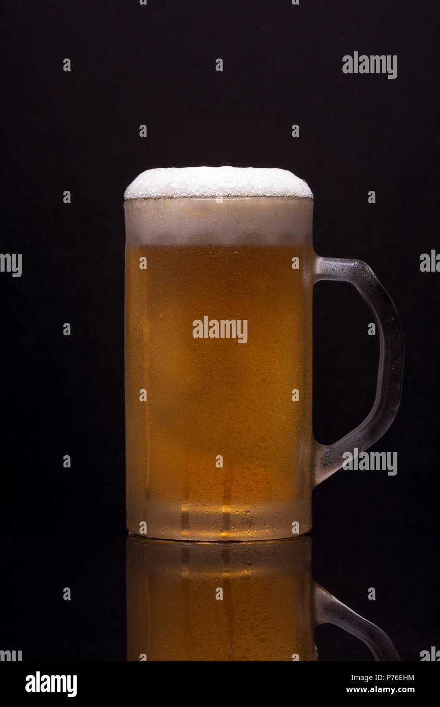 Cold mug with blonde beer Stock Photo