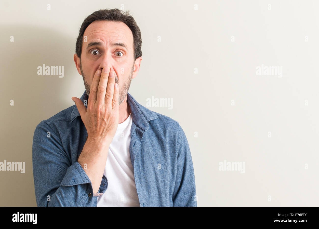 Senior man cover mouth with hand shocked with shame for mistake