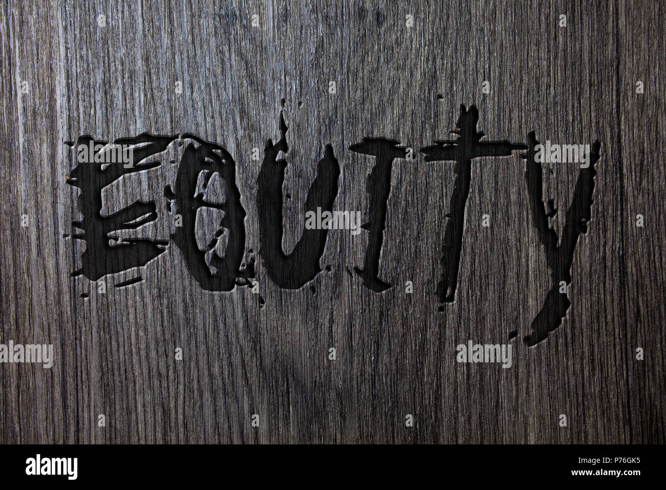 Word writing text Equity. Business concept for Value of a company divided into equal parts owned by shareholders Wooden wood background black engraved Stock Photo