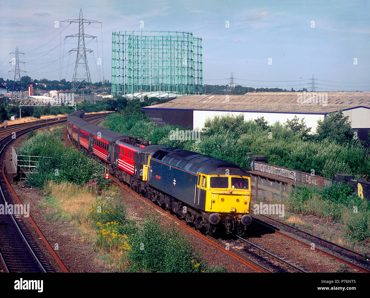 A class 47 diesel locomotive number 47840 'North Star' with a class 87 electric locomotive number 87012 in tow working a diverted Virgin Trains West Coast service at Saltley Viaduct in Birmingham on the 2nd August 2003. Stock Photo