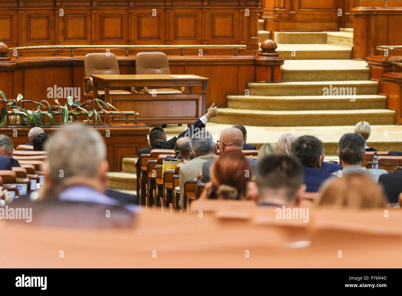BUCAREST, ROMANIA - JULY 4, 2018: The lider of a parliamentary group signals to his coleagues how to vote during a debate for changing a law Stock Photo