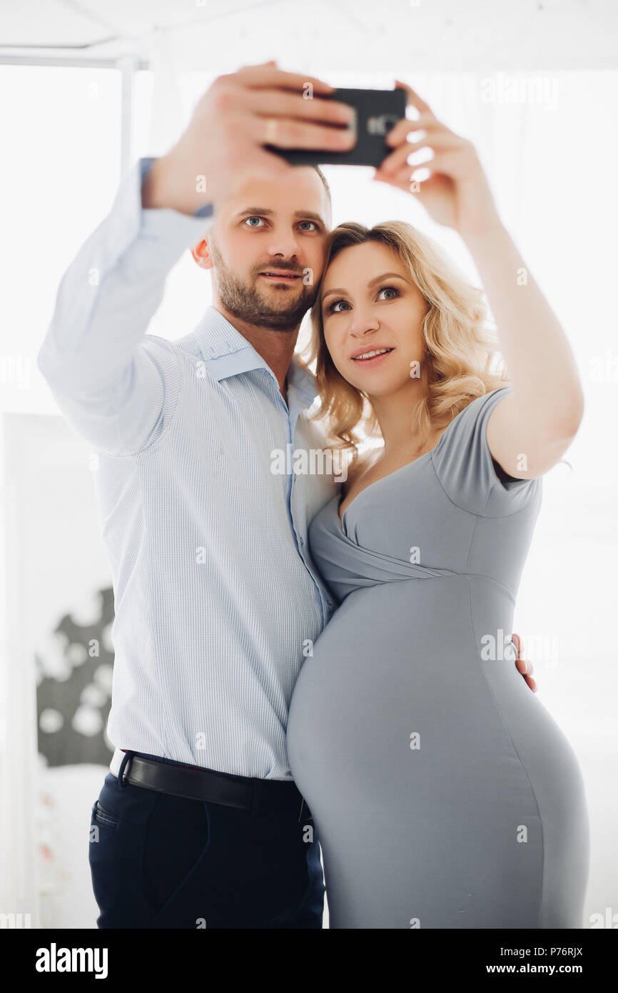 Couple handsome man and pregnant woman taking self portrait Stock Photo ...