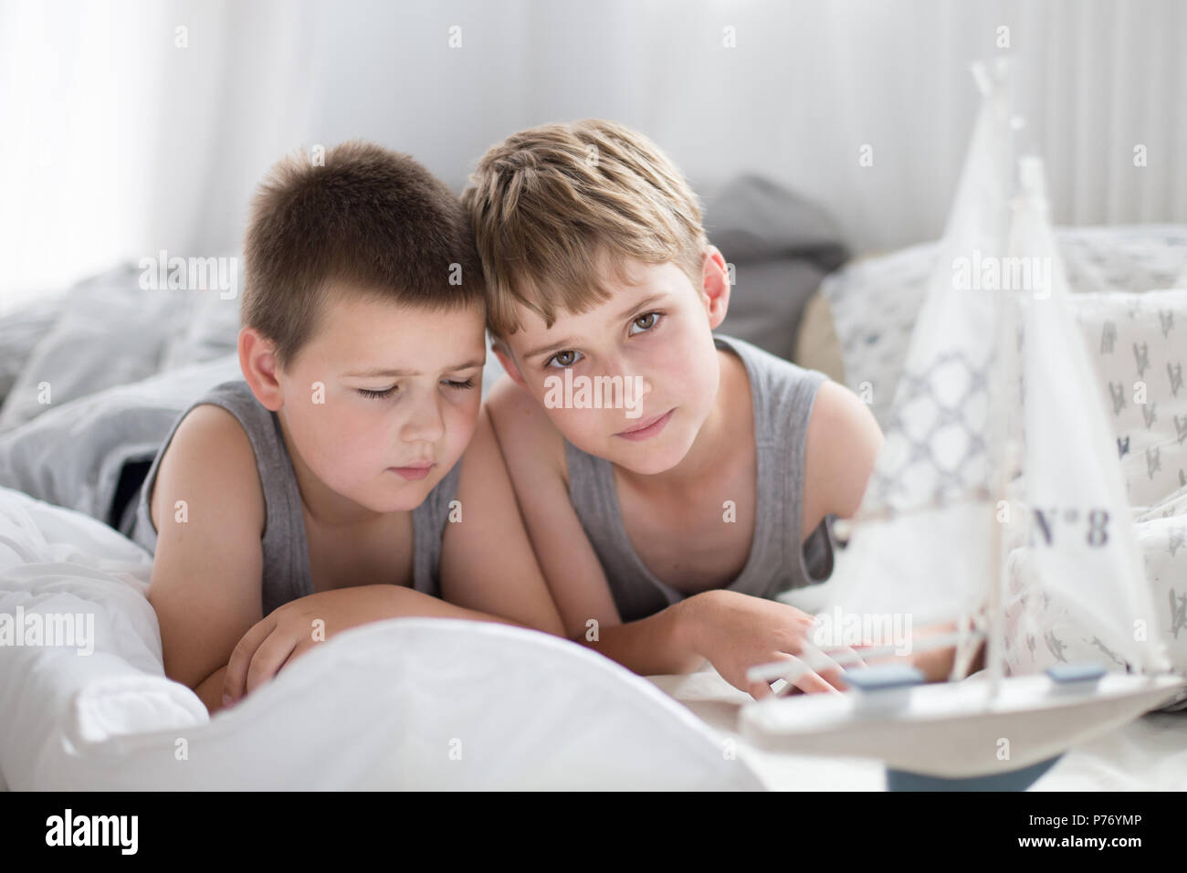 Brothers - a lazy morning in bed, bedding. Fun and rest, relax, lazy Sunday Stock Photo