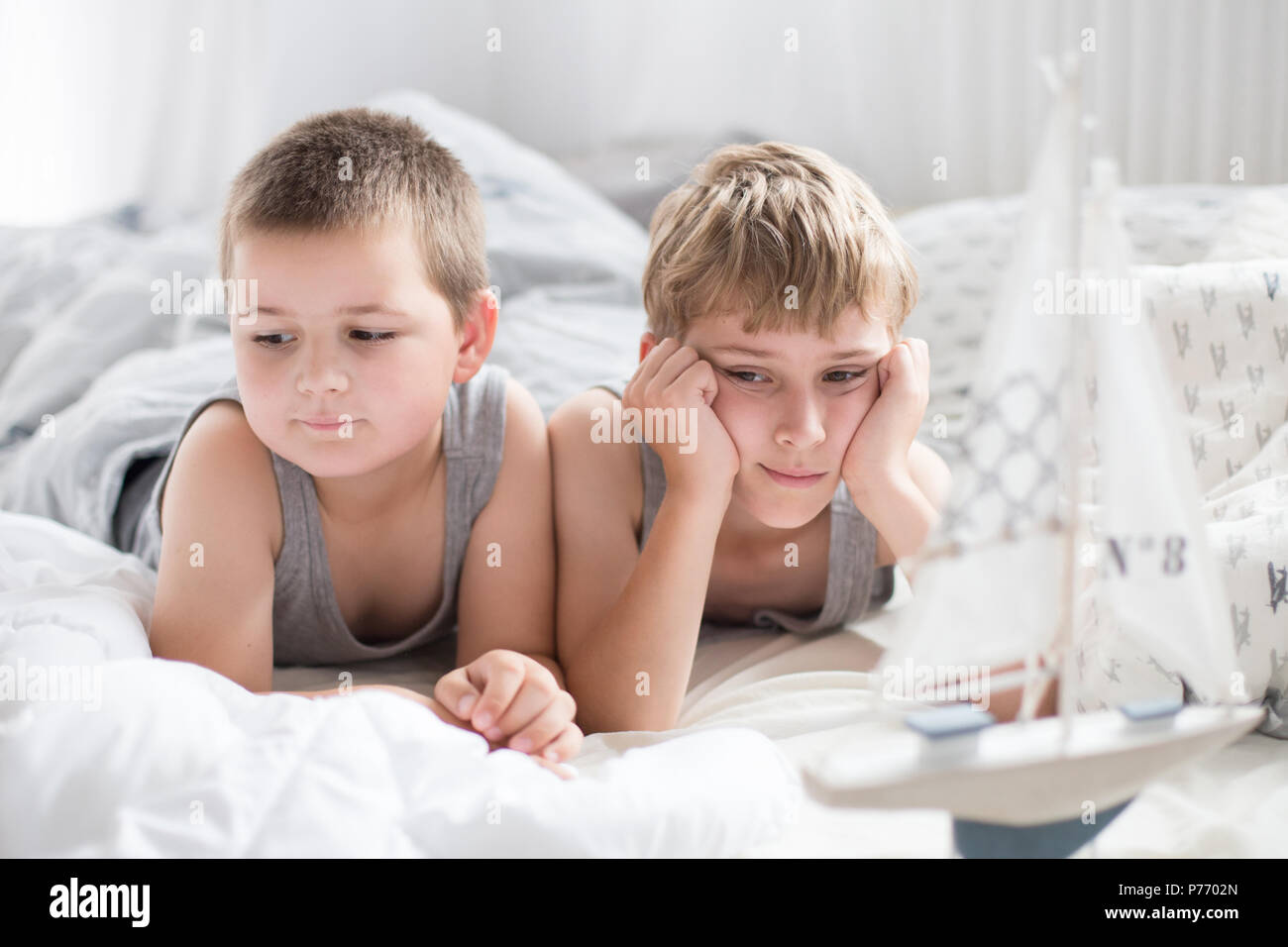 Brothers a lazy morning in bed, bedding. Fun and rest, relax, lazy