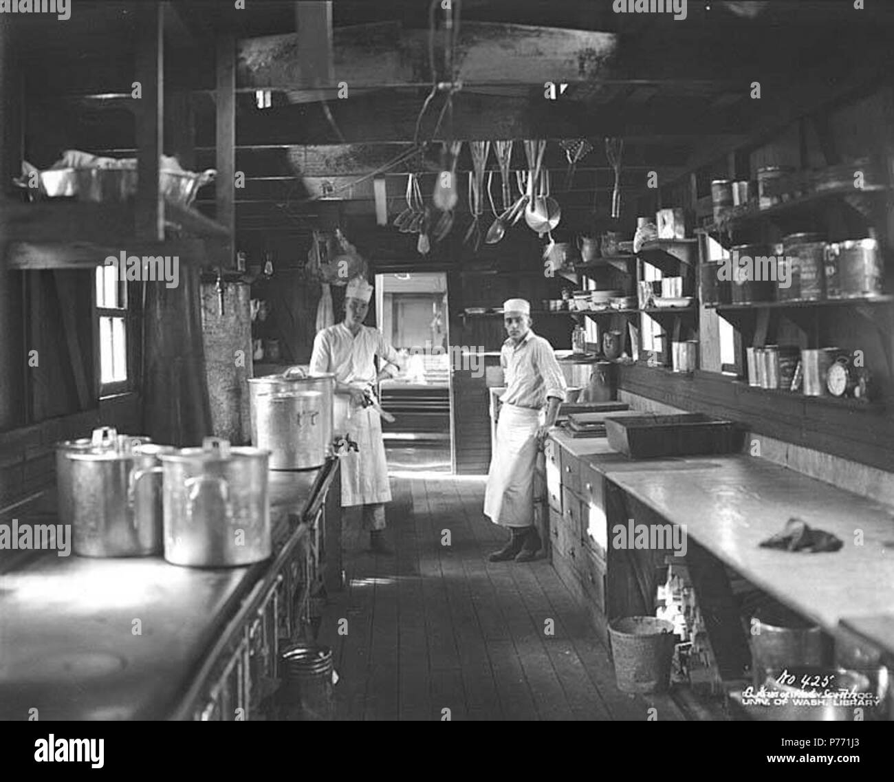 . English: Camp galley interior and cooks, Cascade Timber Company, ca. 1927 . English: PH Coll 516.317 Subjects (LCTGM): Cooks; Kitchens--Washington (State); Lumber camps--Washington (State); Interiors--Washington (State); Lumber industry--Washington (State); Cascade Timber Company--People--Washington (State); Cascade Timber Company--Facilities--Washington (State); Pierce County  . circa 1927 1 Camp galley interior and cooks, Cascade Timber Company, ca 1927 (KINSEY 12) Stock Photo