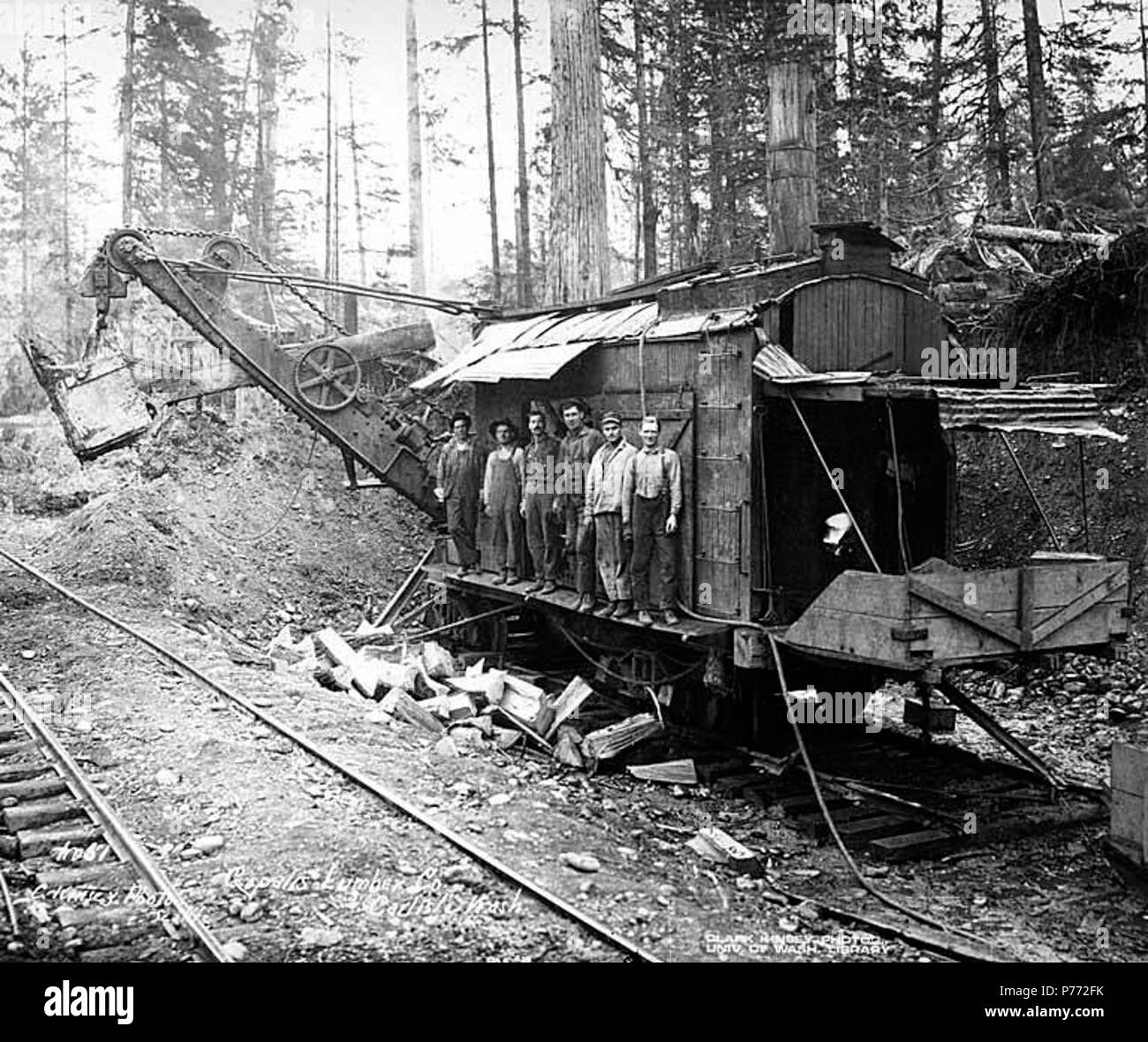 . English: Construction crew and steam shovel, Copalis Lumber Company, near Carlisle, ca. 1918 . English: Caption on image: Copalis Lumber Co., Carlisle, Wash. C. Kinsey Photo, Seattle. No. 51 PH Coll 516.817 The Copalis Lumber Company was in business in Carlisle from 1914 to 1920. It's logging railroad was absorbed into the Carlisle Lumber Company. Carlisle is a small settlement on the Copalis River four miles east of the Pacific Ocean in southwest Grays Harbor County. When established in 1912 by the Carlisle Lumber Company, it was a busy logging and sawmill center. It continued to be active  Stock Photo