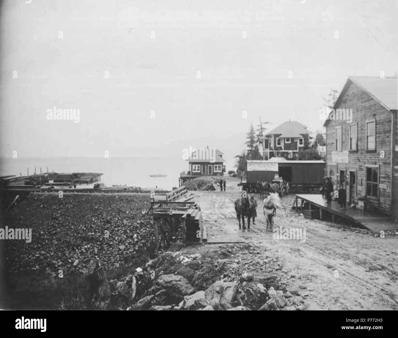 . English: Cordova showing portion of town with railroad tracks in background, ca. 1908 . English: Construction photographs of the Copper River and Northwestern Railway along the Copper River from 1906-1911. PH Coll 375.5 Subjects (LCTGM): Cities & towns--Alaska; Streets--Alaska--Cordova; Horses--Alaska--Cordova; Railroad tracks--Alaska--Cordova Subjects (LCSH): Cordova (Alaska)  . 1908 3 Cordova showing portion of town with railroad tracks in background, ca 1908 (HEGG 738) Stock Photo