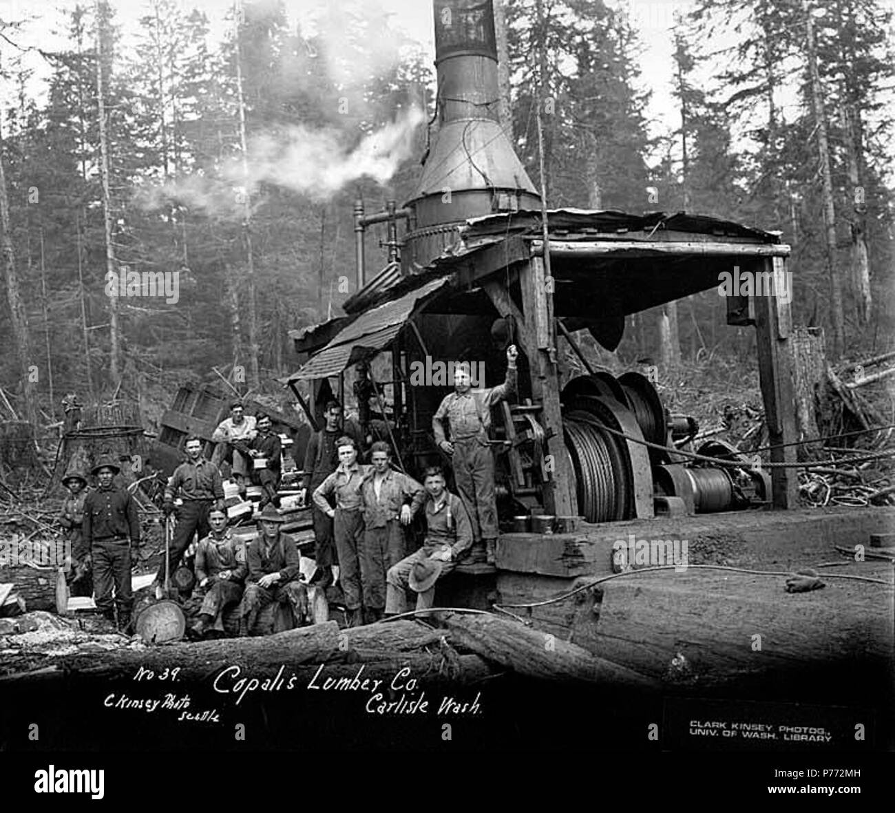 . English: Crew with donkey engine, Copalis Lumber Company, near Carlisle, ca. 1917 . English: Caption on image: Copalis Lumber Co., Carlisle, Wash. C. Kinsey Photo, Seattle. No. 39 PH Coll 516.813 The Copalis Lumber Company was in business in Carlisle from 1914 to 1920. It's logging railroad was absorbed into the Carlisle Lumber Company. Carlisle is a small settlement on the Copalis River four miles east of the Pacific Ocean in southwest Grays Harbor County. When established in 1912 by the Carlisle Lumber Company, it was a busy logging and sawmill center. It continued to be active until the c Stock Photo