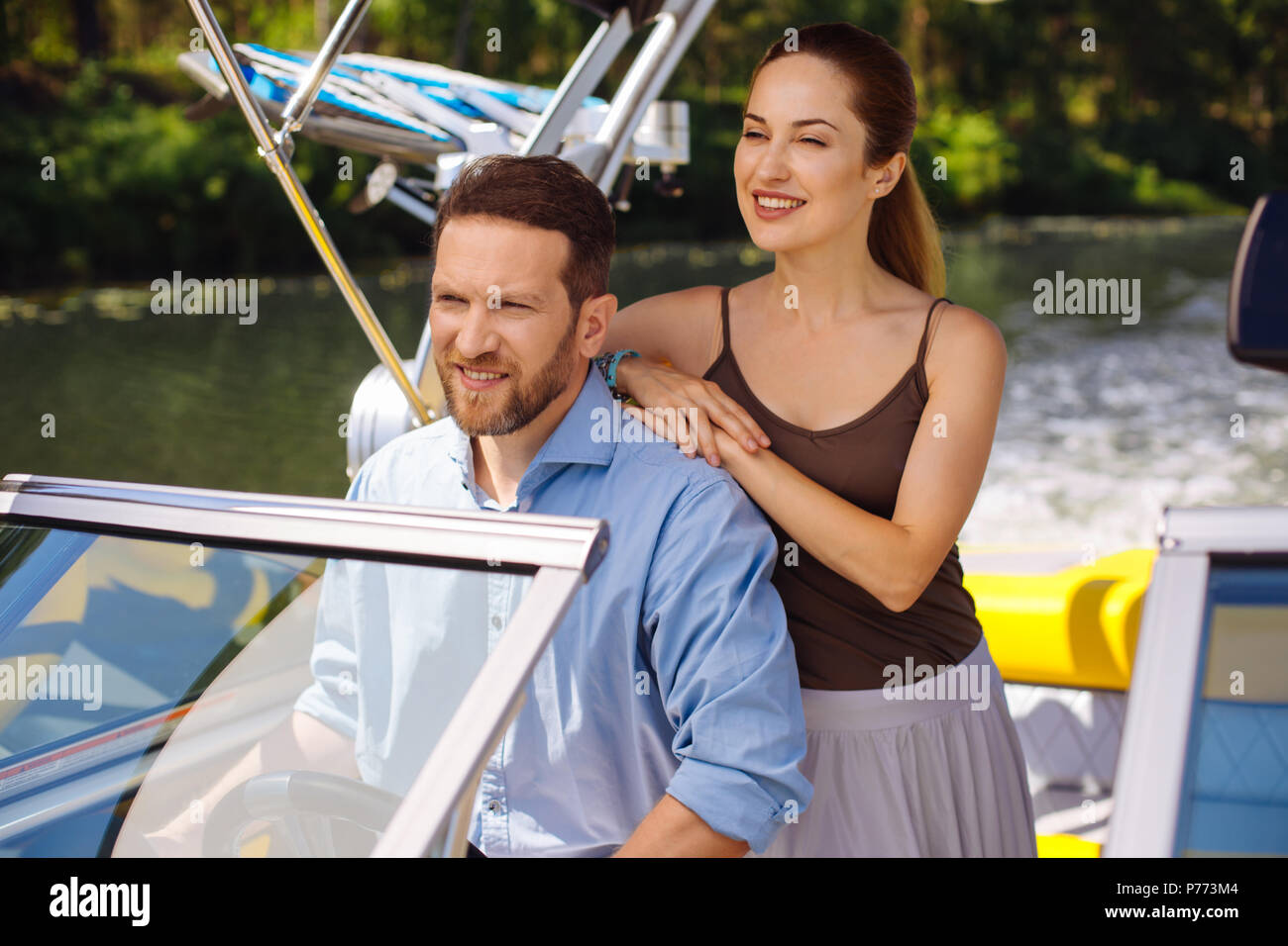 Pleasant couple enjoying view while sailing boat Stock Photo