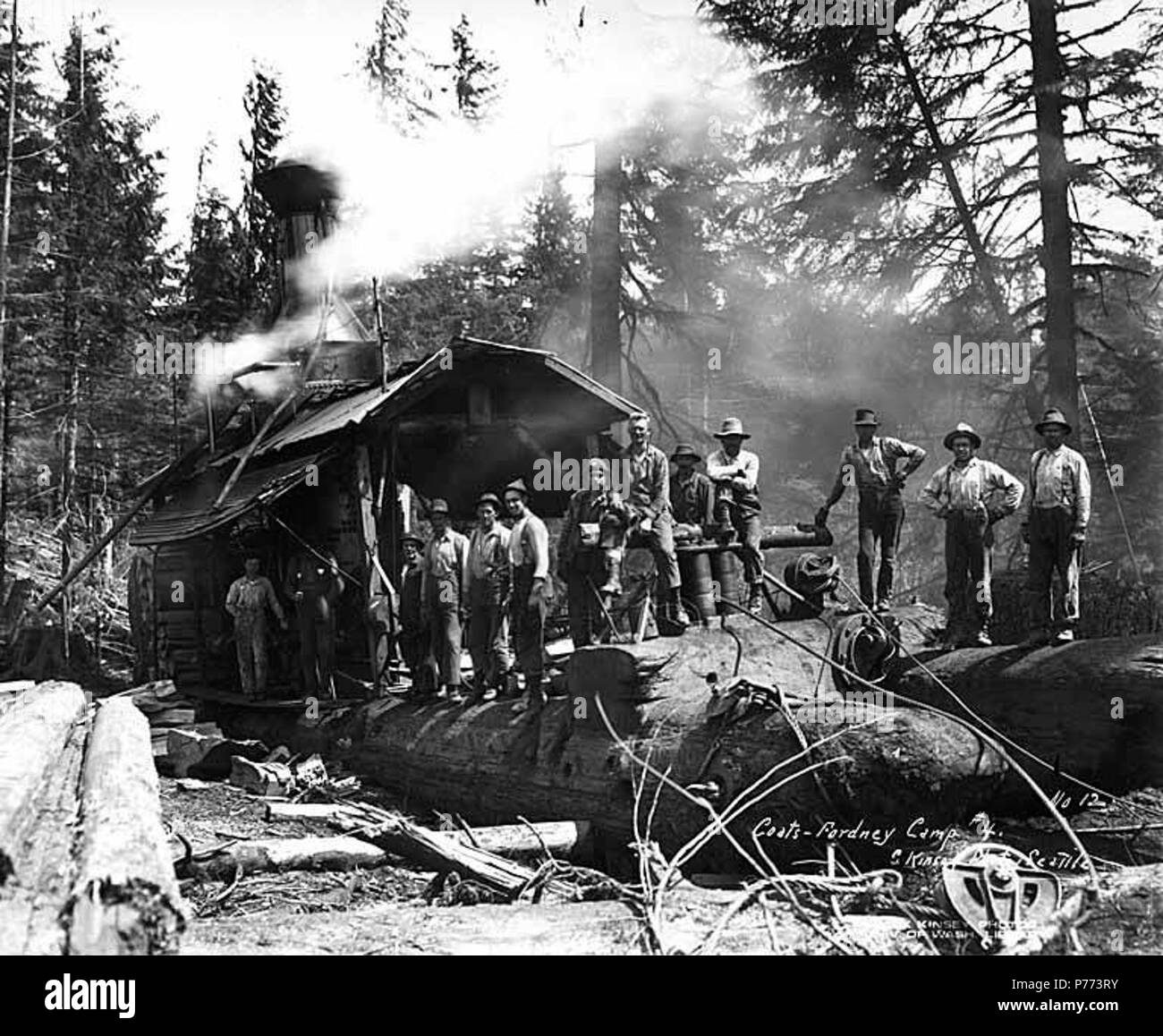 . English: Loading crew and donkey engine, camp 4, Coats-Fordney Lumber Company, near Aberdeen, ca. 1920 . English: Caption on image: Coats-Fordney, Camp #4. C. Kinsey Photo, Seattle. No. 12 PH Coll 516.626 The Coats-Fordney Lumber Company started out as the A.F. Coats Lumber Company in 1905, headquartered in Aberdeen. It became the Coats-Fordney Lumber Company in 1910, and by 1924, it was called the Donovan-Corkery Lumber Company. Aberdeen is a city in Grays Harbor (formerly called Chehalis) County. The town was platted by Samuel Benn in 1884 on his homestead. Benn was born in New York City a Stock Photo