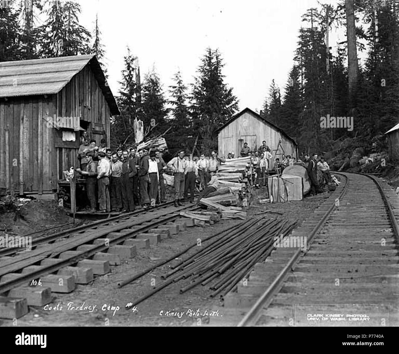 . English: Loggers at camp 4, Coats-Fordney Lumber Company, near Aberdeen, ca. 1920 . English: Caption on image: Coats Fordney, Camp #4. C. Kinsey Photo, Seattle. No. 6 PH Coll 516.622 The Coats-Fordney Lumber Company started out as the A.F. Coats Lumber Company in 1905, headquartered in Aberdeen. It became the Coats-Fordney Lumber Company in 1910, and by 1924, it was called the Donovan-Corkery Lumber Company. Aberdeen is a city in Grays Harbor (formerly called Chehalis) County. The town was platted by Samuel Benn in 1884 on his homestead. Benn was born in New York City and in 1856 he came to  Stock Photo