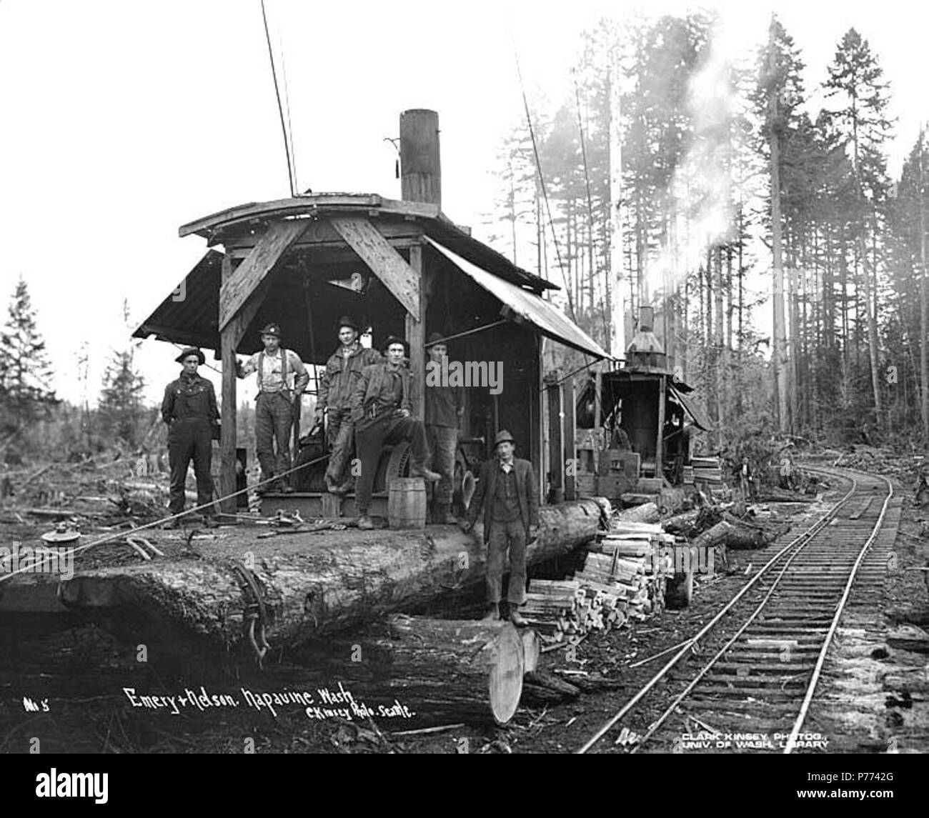 . English: Logging crew and donkey engine beside railroad track, Emery and Nelson, Inc., ca. 1917 . English: Caption on image: Emery & Nelson, Napavine, Wash. C. Kinsey Photo, Seattle. No. 5 PH Coll 516.1136 Emery & Nelson, Inc. was in business from ca. 1909 to ca. 1928, headquartered in Napavine in Lewis County. Napavine is seven miles southeast of Chehalis on the Newaukum River in west central Lewis County. It is on John Urquhart's Donation Land Claim. On December 17,1863, it was named by James Urquhart, using the Indian name which means small prairie. In 1873, Northern Pacific Railway offic Stock Photo