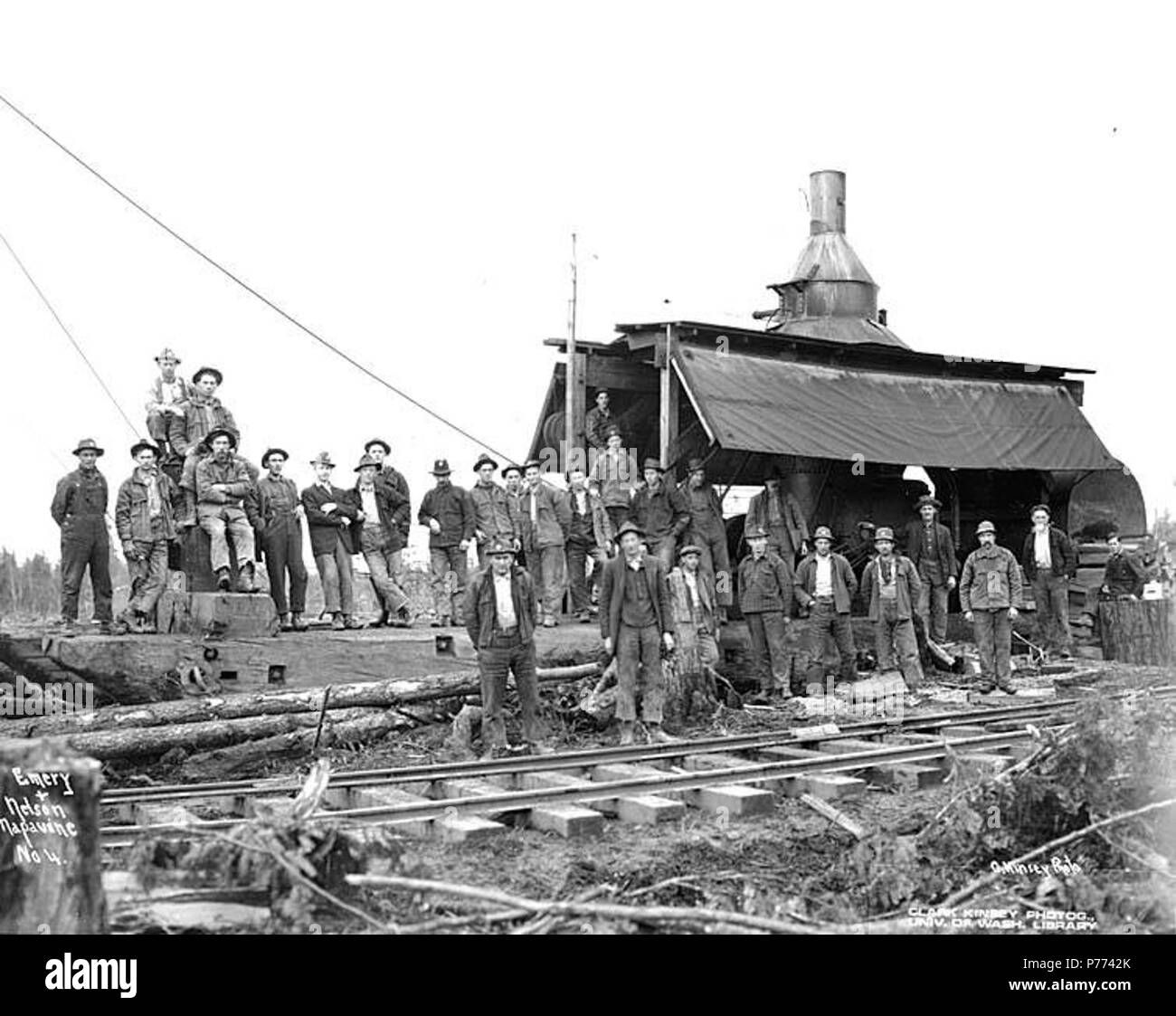 . English: Logging crew and donkey engine beside railroad track, Emery and Nelson, Inc., ca. 1917 . English: Caption on image: Emery & Nelson, Napavine, Wash. C. Kinsey Photo. No. 4 PH Coll 516.1135 Emery & Nelson, Inc. was in business from ca. 1909 to ca. 1928, headquartered in Napavine in Lewis County. Napavine is seven miles southeast of Chehalis on the Newaukum River in west central Lewis County. It is on John Urquhart's Donation Land Claim. On December 17,1863, it was named by James Urquhart, using the Indian name which means small prairie. In 1873, Northern Pacific Railway officials acce Stock Photo