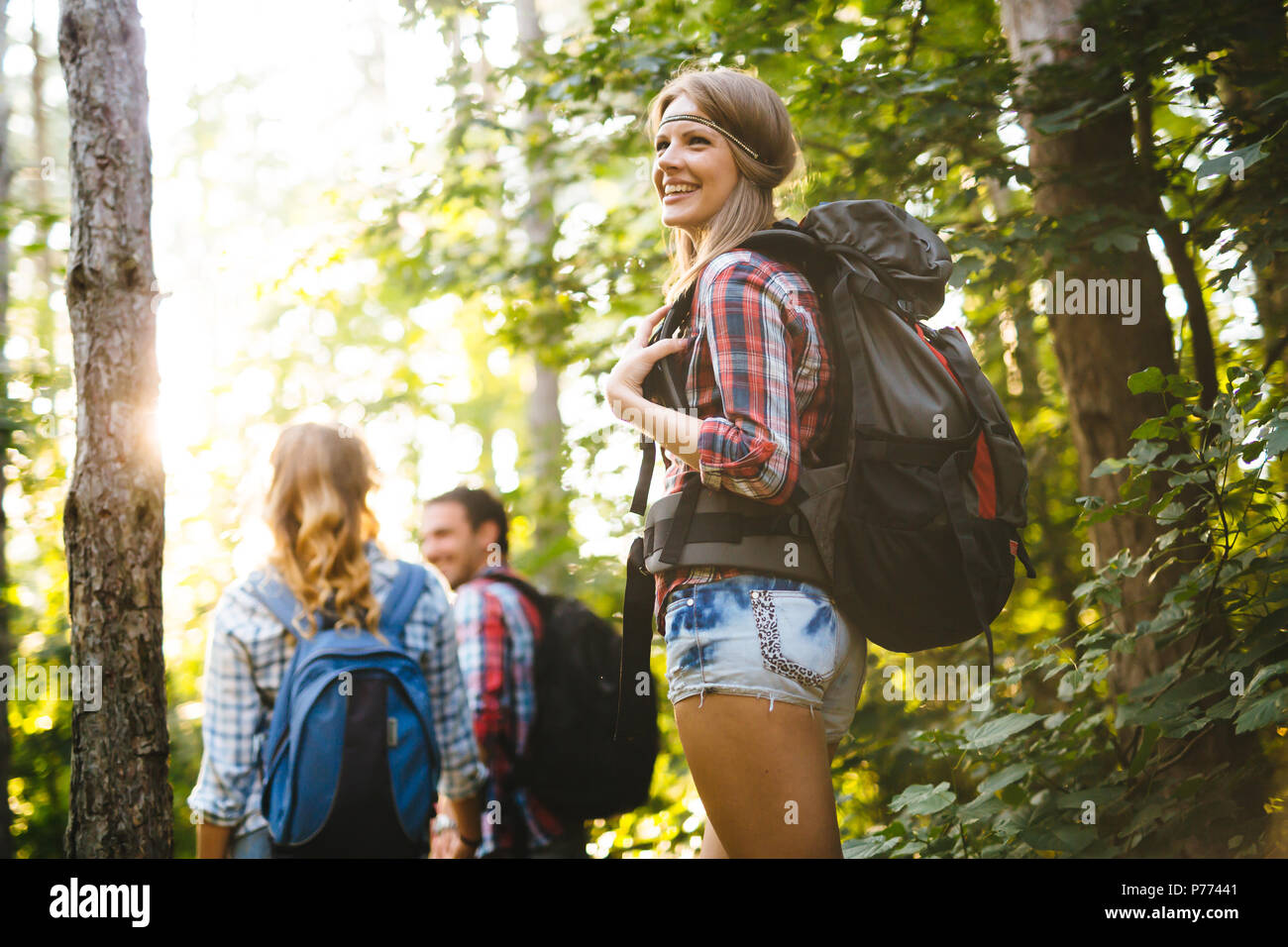 Group of people hiking in forest Stock Photo