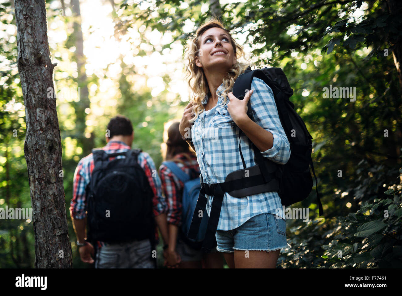 Group of backpacking hikers going for forest trekking Stock Photo Alamy
