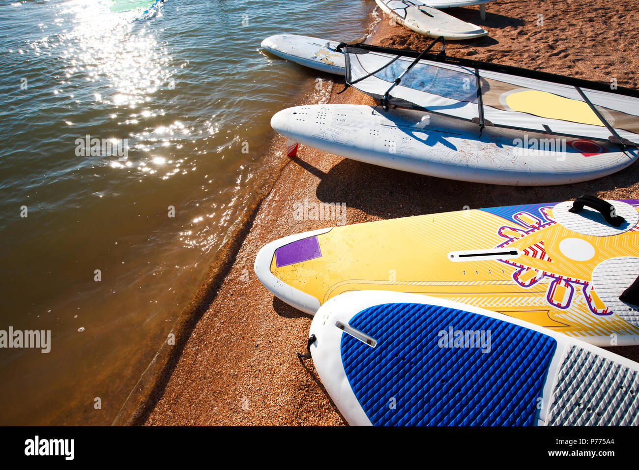 Windsurf boards on the sand at the beach. Windsurfing and active